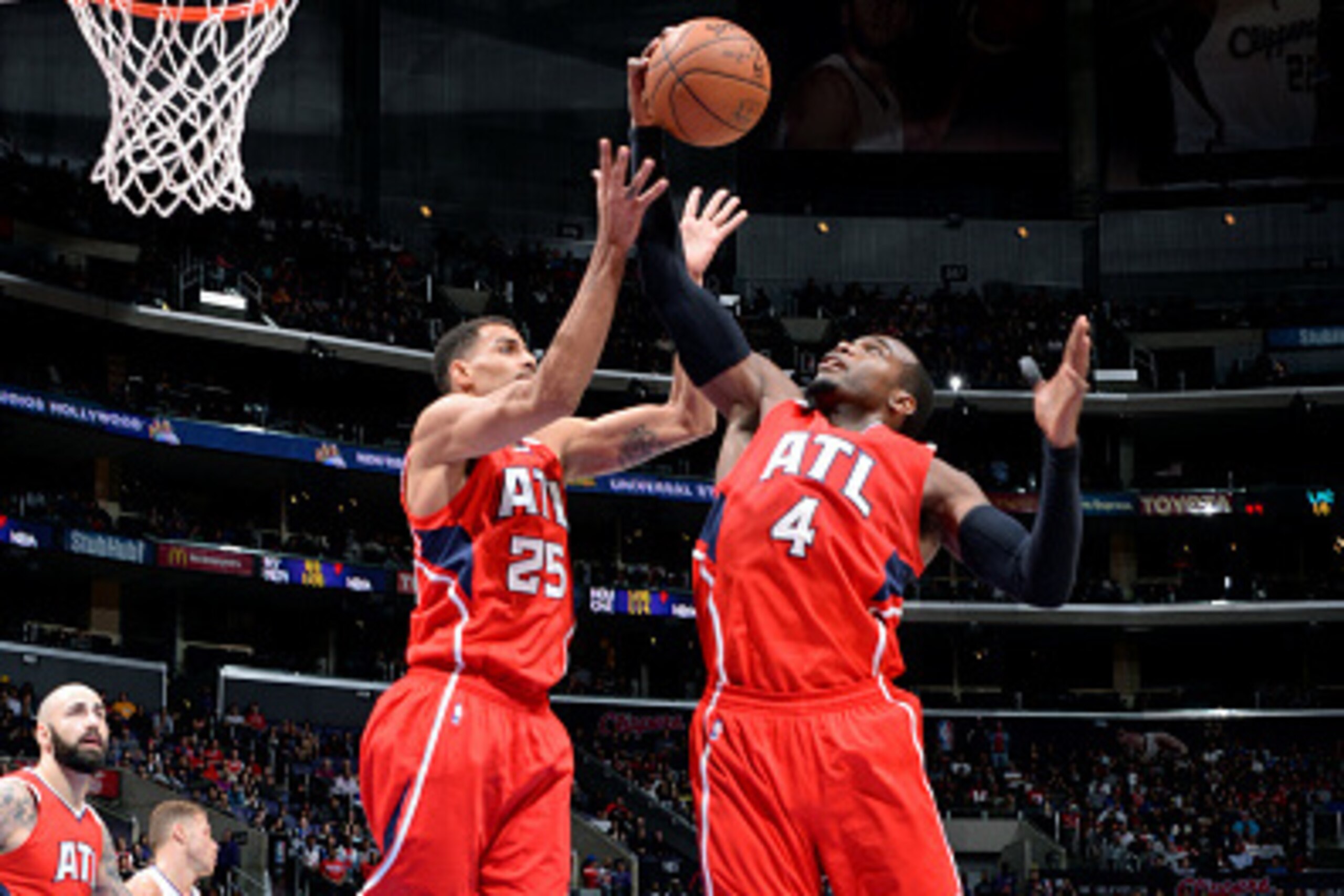 LOS ANGELES, CA - JANUARY 5: Thabo Sefolosha #25 and Paul Millsap #4 of the Atlanta Hawks jump for a rebound against the Los Angeles Clippers on January 5, 2015 at STAPLES Center in Los Angeles, California. NOTE TO USER: User expressly acknowledges and ag