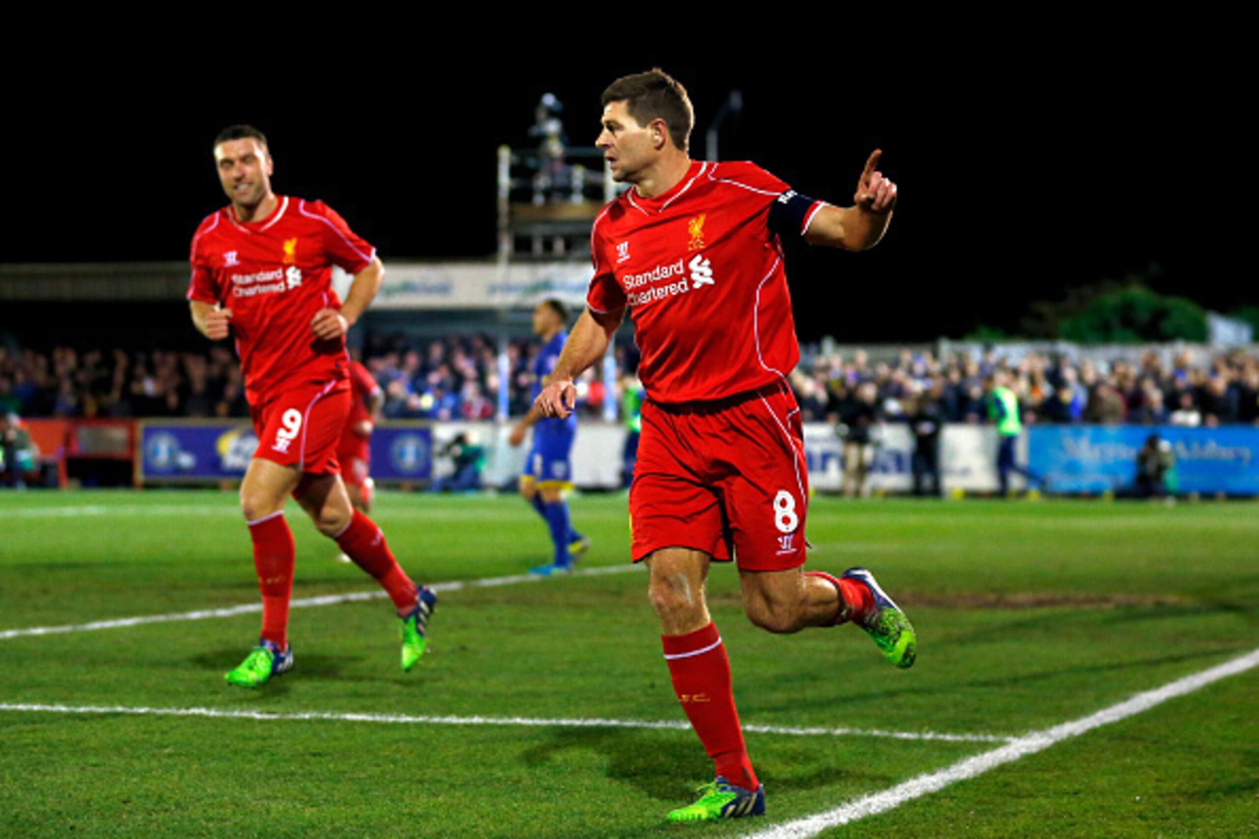 KINGSTON UPON THAMES, ENGLAND - JANUARY 05:  Steven Gerrard of Liverpool celebrates after scoring the opening goal with a header during the FA Cup Third Round match between AFC Wimbledon and Liverpool at The Cherry Red Records Stadium on January 5, 2015 i