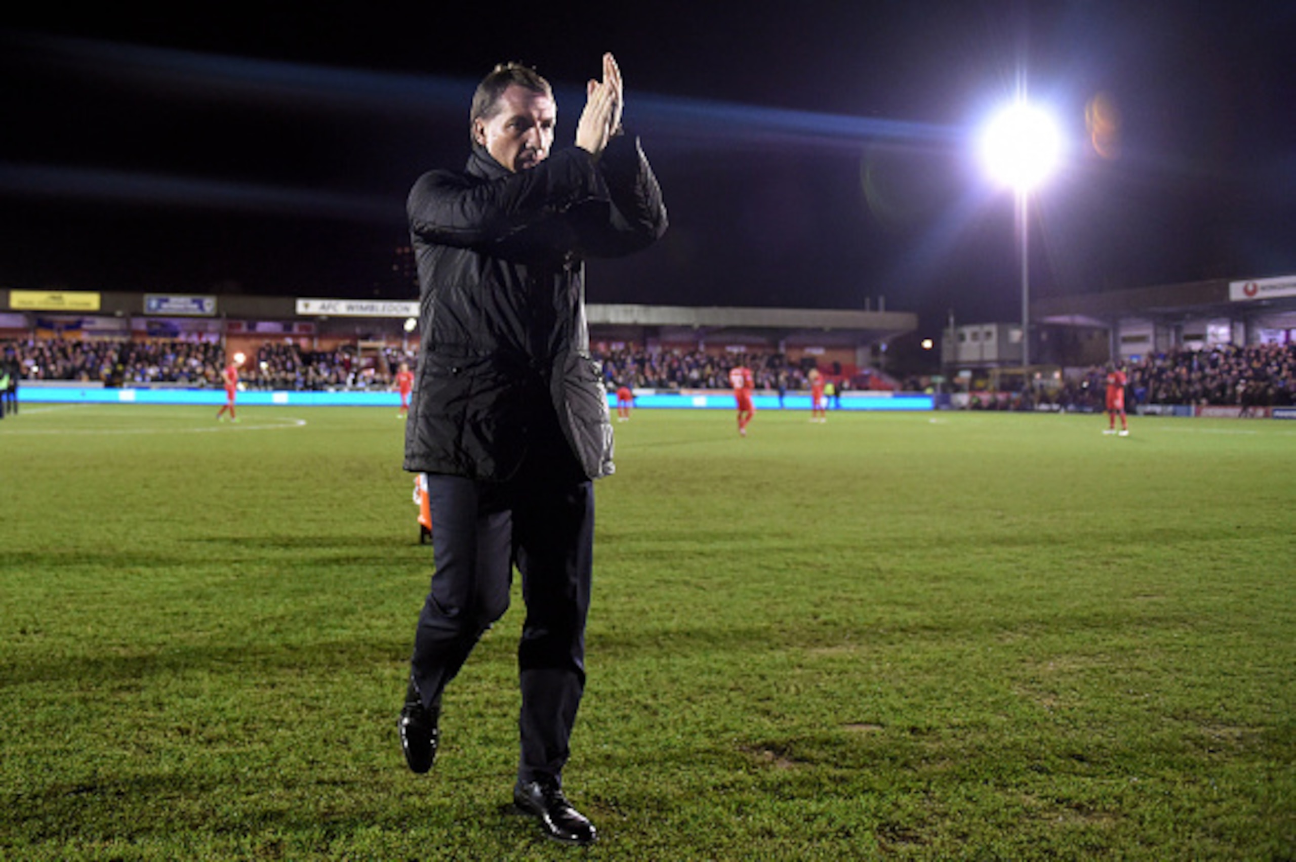 KINGSTON UPON THAMES, ENGLAND - JANUARY 05:  Brendan Rodgers the manager of Liverpool acknowledges the fans prior to kickoff during the FA Cup Third Round match between AFC Wimbledon and Liverpool at The Cherry Red Records Stadium on January 5, 2015 in Ki