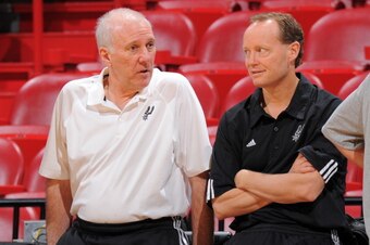 MIAMI, FL - JUNE 19: Head Coach Gregg Popovich speaks to Assistant Coach Mike Budenholzer of the San Antonio Spurs during practice as part of the 2013 NBA Finals on June 19, 2013 at American Airlines Arena in Miami, Florida. NOTE TO USER: User expressly a