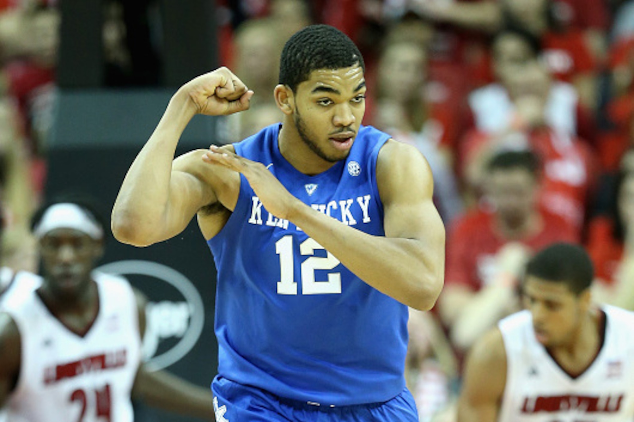 LOUISVILLE, KY - DECEMBER 27:  Karl-Anthony Towns #12  of the Kentucky Wildcats celebrates by flexing his muscles during the game against the Louisville Cardinals at KFC YUM! Center on December 27, 2014 in Louisville, Kentucky.  Kentucky won 58-50.  (Phot