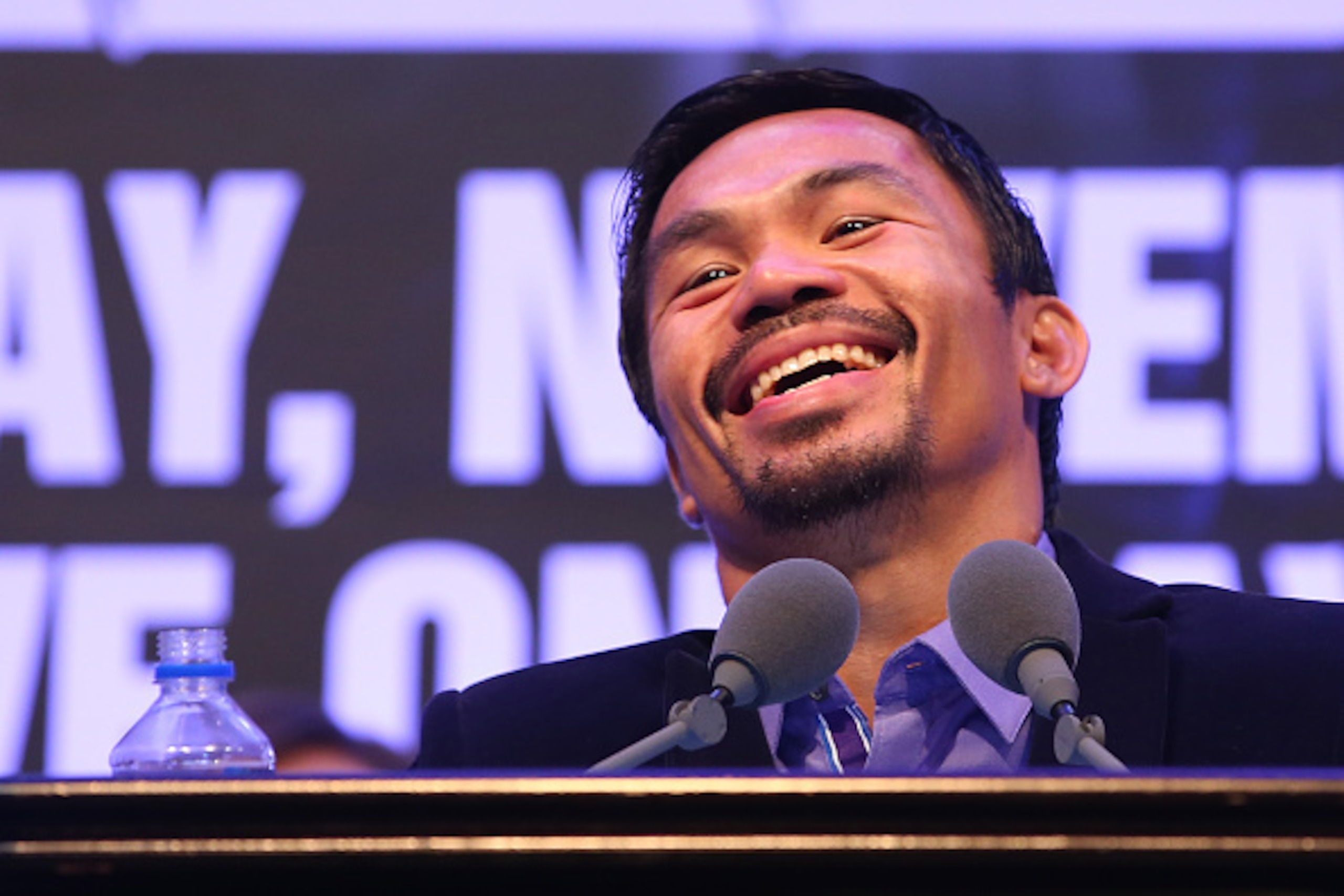 MACAU - NOVEMBER 23:  Manny Pacquiao of the Philippines speaks to media at the post fight press conference after winning against Chris Algieri of the United States during the WBO world welterweight title at The Venetian on November 23, 2014 in Macau, Maca