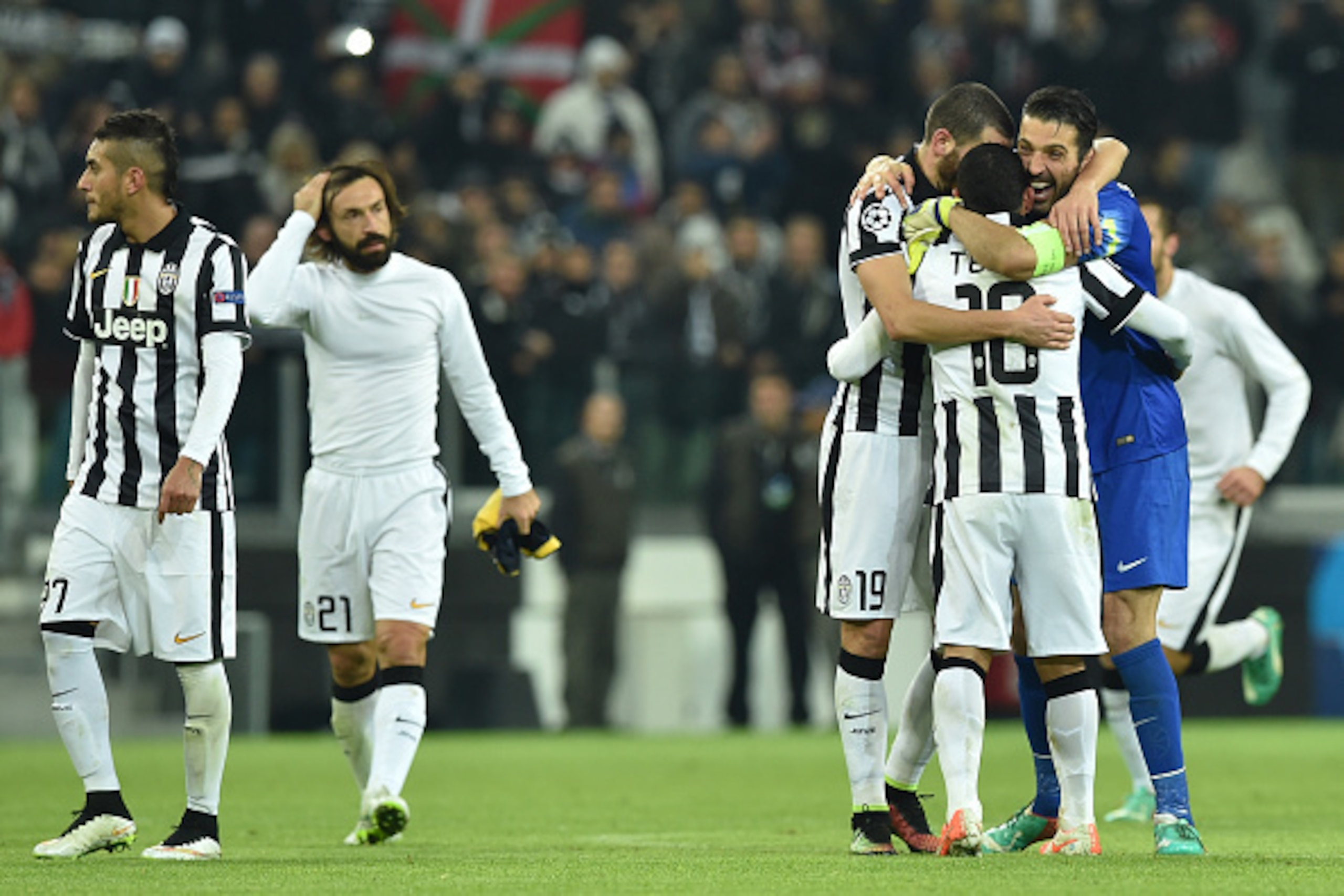 TURIN, ITALY - DECEMBER 09:  Leonardo Bonucci, Gianluigi Buffon and Carlos Tevez of Juventus celebrate at the end of the UEFA Champions League group A match between Juventus and Club Atletico de Madrid at Juventus Arena on December 9, 2014 in Turin, Italy