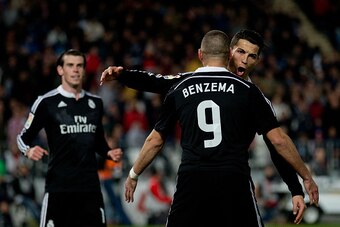 ALMERIA, SPAIN - DECEMBER 12:  Cristiano Ronaldo (R) of Real Madrid CF celebrates scoring their third goal with teammate Karim Benzema (L) as Gareth Bale (L) runs to them during the La Liga match between UD Almeria and Real Madrid CF at Juegos del Mediter