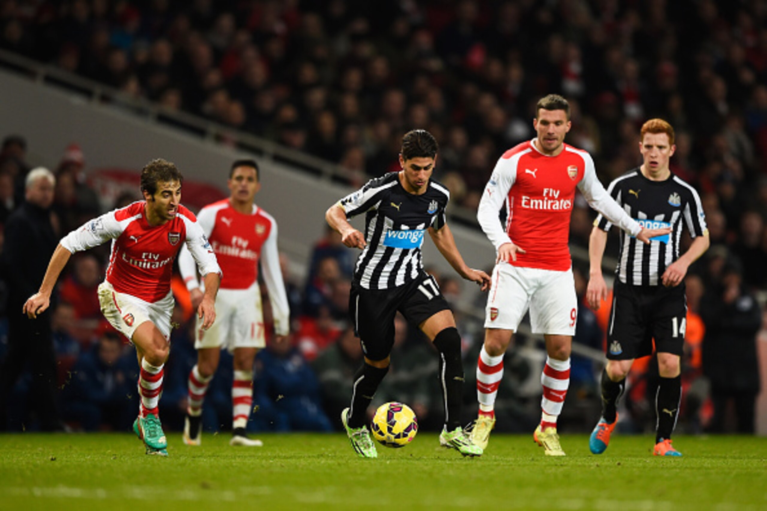 LONDON, ENGLAND - DECEMBER 13: Ayoze Perez of Newcastle United goes past Mathieu Flamini of Arsenal during the Barclays Premier League match between Arsenal and Newcastle United at Emirates Stadium on December 13, 2014 in London, England.  (Photo by Mike 