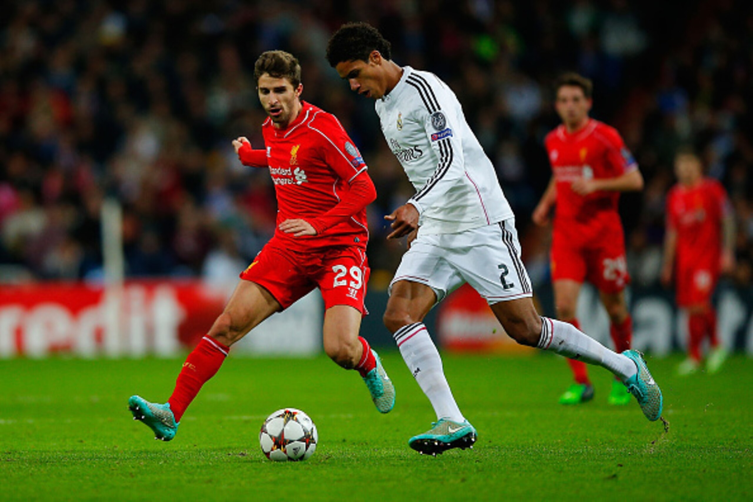 MADRID, SPAIN - NOVEMBER 04: Raphael Varane (R) of Real Madrid CF competes for the ball with Fabio Borini (L) of Liverpool FC during the UEFA Champions League Group B match between Real Madrid CF and Liverpool FC at Estadio Santiago Bernabeu on November 4 MADRID, SPAIN - NOVEMBER 04: Raphael Varane (R) of Real Madrid CF competes for the ball with Fabio Borini (L) of Liverpool FC during the UEFA Champions League Group B match between Real Madrid CF and Liverpool FC at Estadio Santiago Bernabeu on November 4