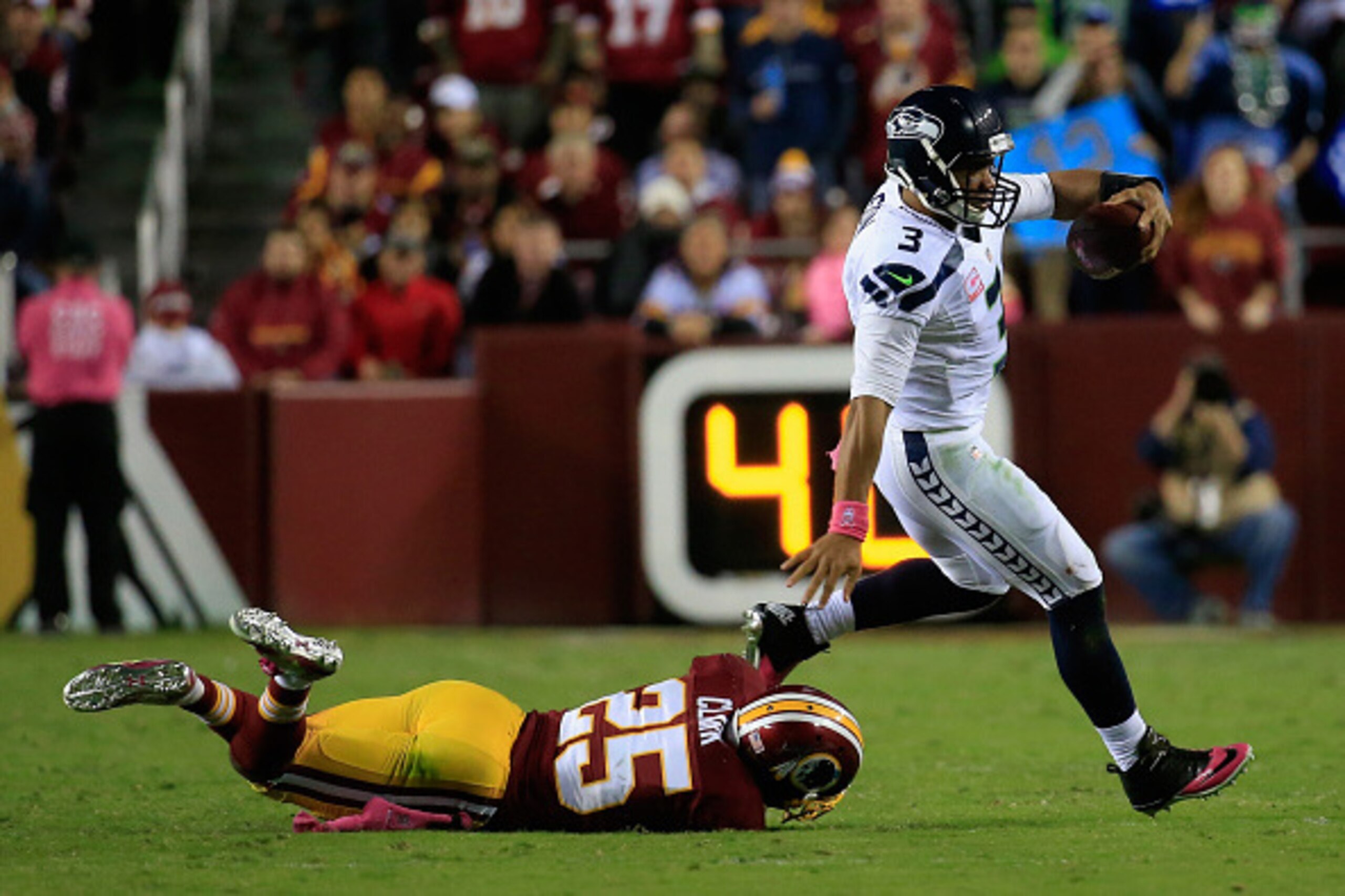 LANDOVER, MD - OCTOBER 06: Quarterback Russell Wilson #3 of the Seattle Seahawks eludes the tackle of free safety Ryan Clark #25 of the Washington Redskins in the second half at FedExField on October 6, 2014 in Landover, Maryland. (Photo by Rob Carr/Gett LANDOVER, MD - OCTOBER 06: Quarterback Russell Wilson #3 of the Seattle Seahawks eludes the tackle of free safety Ryan Clark #25 of the Washington Redskins in the second half at FedExField on October 6, 2014 in Landover, Maryland. (Photo by Rob Carr/Gett