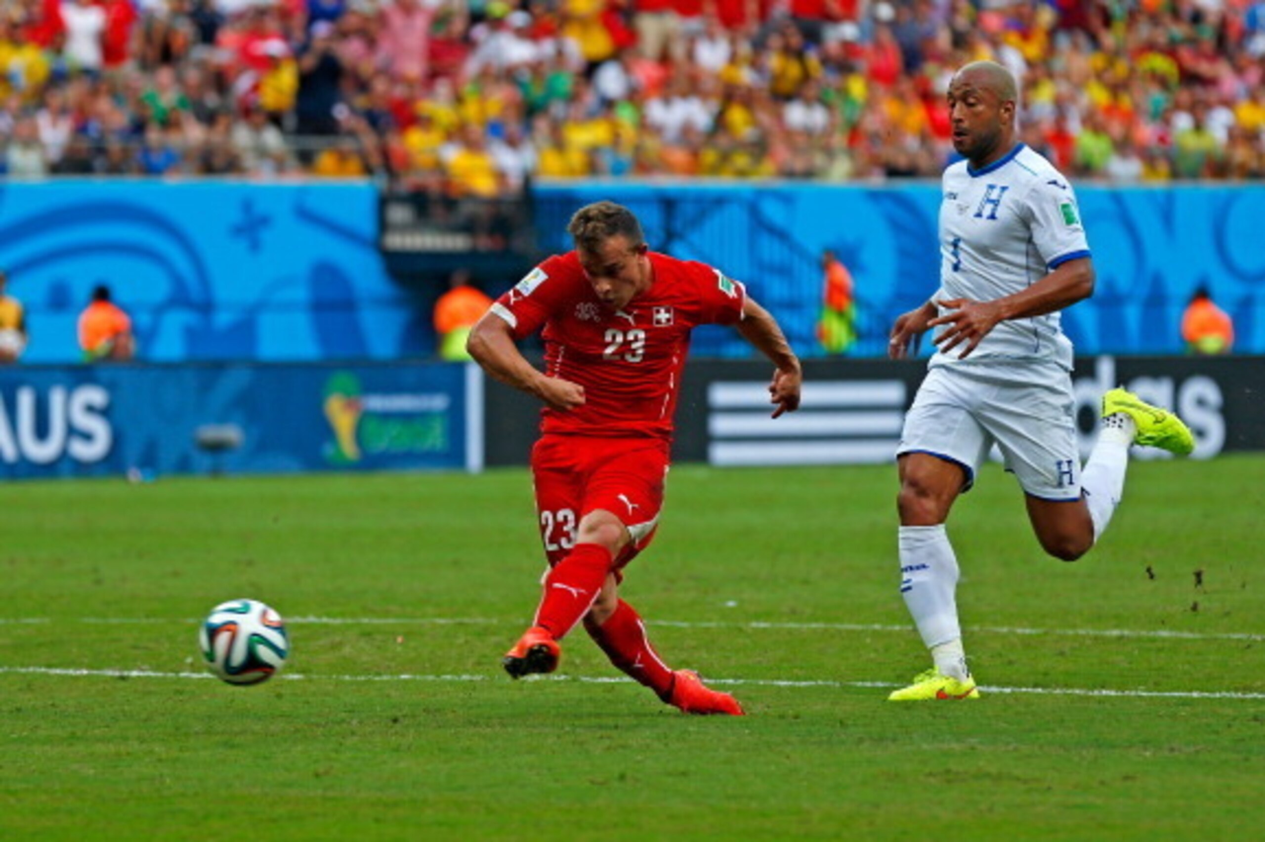 MANAUS, BRAZIL - JUNE 25:  Xherdan Shaqiri of Switzerland shoots and scores his team's second goal during the 2014 FIFA World Cup Brazil Group E match between Honduras and Switzerland at Arena Amazonia on June 25, 2014 in Manaus, Brazil.  (Photo by Matthe