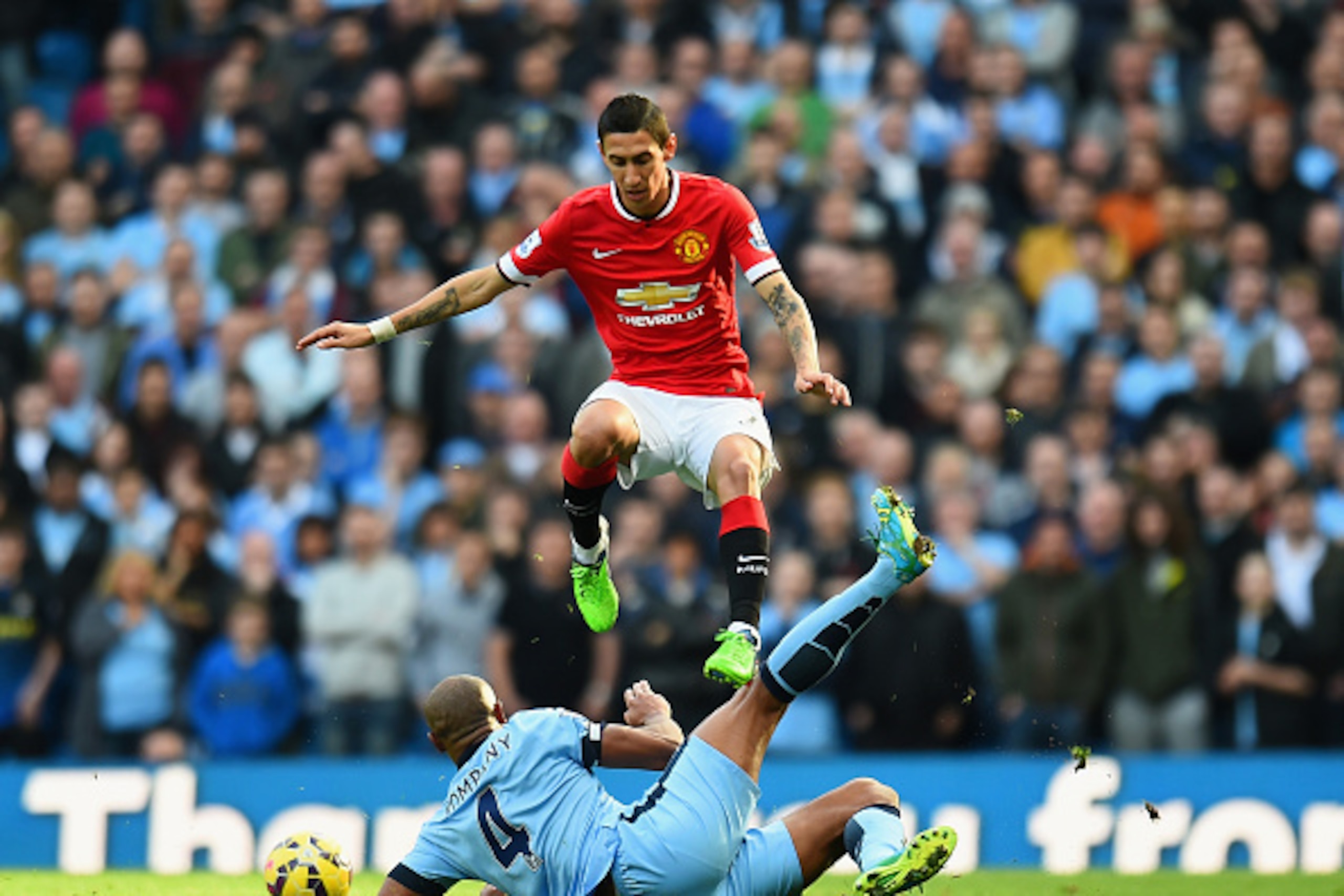 MANCHESTER, ENGLAND - NOVEMBER 02: Angel di Maria of Manchester United leaps over a challenge from Vincent Kompany of Manchester City during the Barclays Premier League match between Manchester City and Manchester United at Etihad Stadium on November 2, 2 MANCHESTER, ENGLAND - NOVEMBER 02: Angel di Maria of Manchester United leaps over a challenge from Vincent Kompany of Manchester City during the Barclays Premier League match between Manchester City and Manchester United at Etihad Stadium on November 2, 2