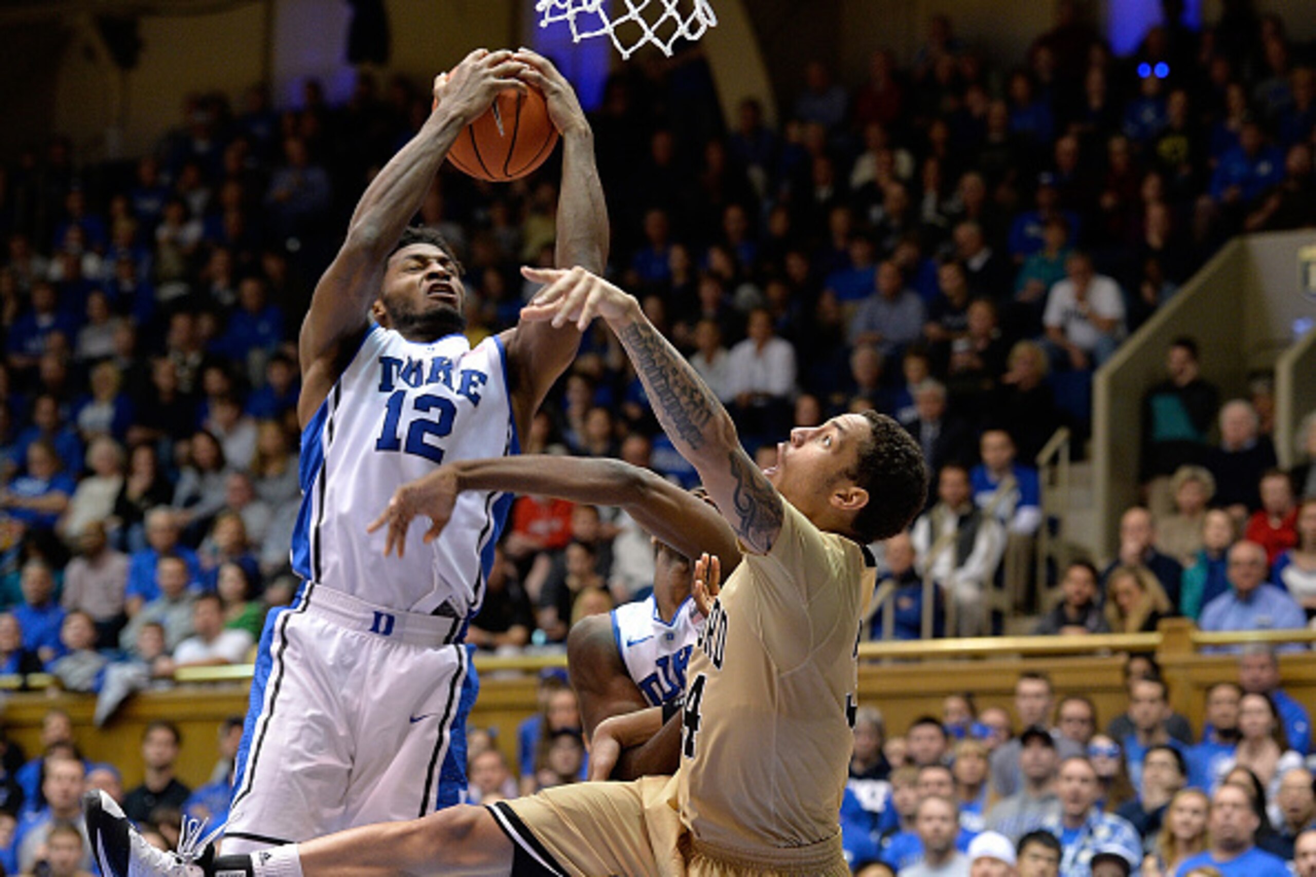 DURHAM, NC - DECEMBER 31: Justise Winslow #12 of the Duke Blue Devils takes a rebound away from Lee Skinner #34 of the Wofford Terriers during their game at Cameron Indoor Stadium on December 31, 2014 in Durham, North Carolina. Duke won 84-55. (Photo by G
