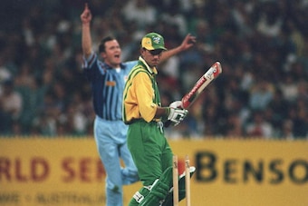 13 DEC 1994:  CRAIG WHITE OF ENGLAND CELEBRATES IN THE BACKGROUND AFTER  BOWLING RICKY PONTING OF AUSTRALIA A  DURING THE AUSTRALIA A V ENGLAND BENSON AND HEDGES WORLD SERIES MATCH AT THE MCG IN MELBOURNE, AUSTRALIA. ENGLAND WON THE MATCH BY 31 RUNS. Mand