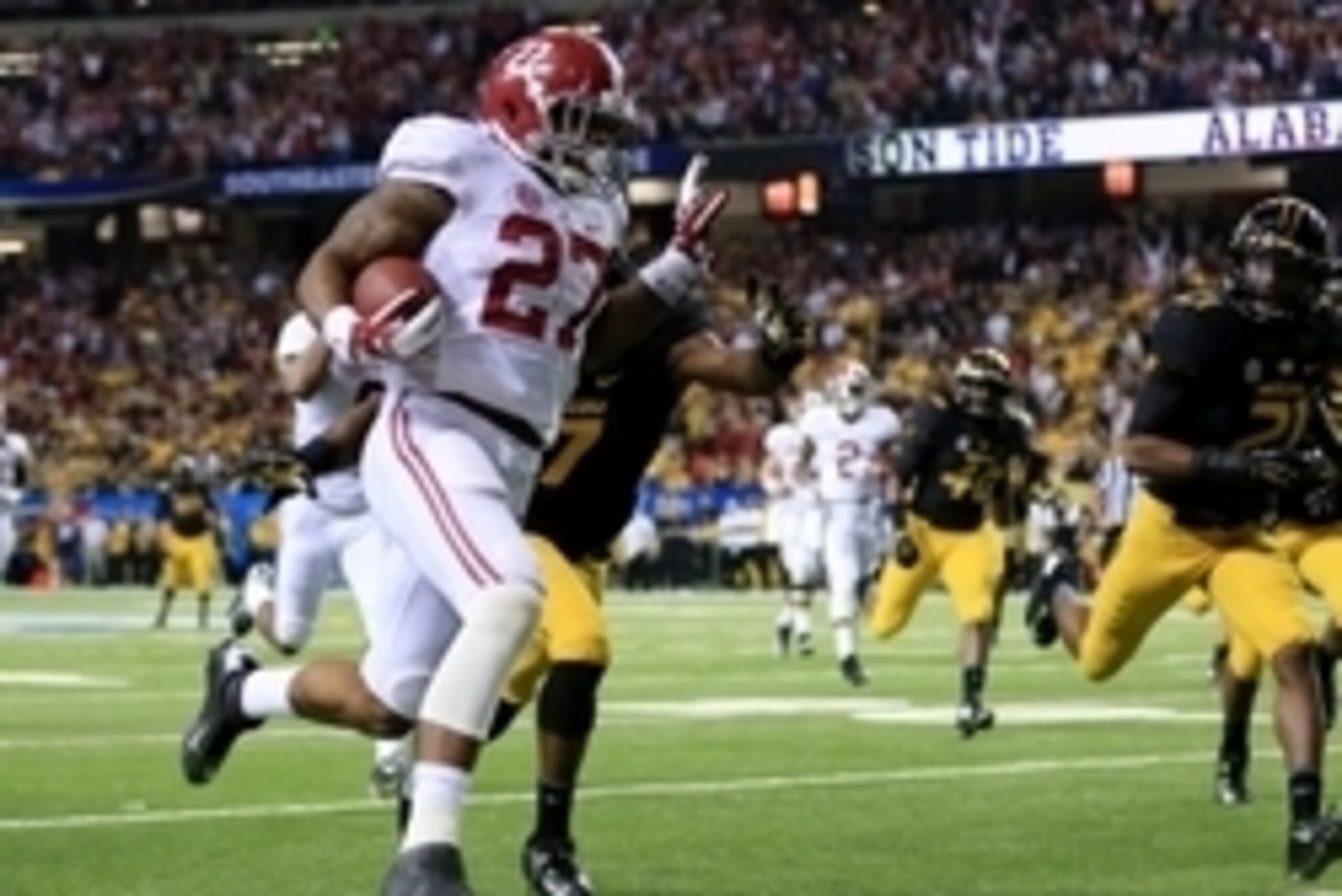 Dec 6, 2014; Atlanta, GA, USA; Alabama Crimson Tide running back Derrick Henry (27) scores the final touchdown during the fourth quarter of the 2014 SEC Championship Game against the Missouri Tigers at the Georgia Dome. Alabama defeated Missouri 42-13. Ma