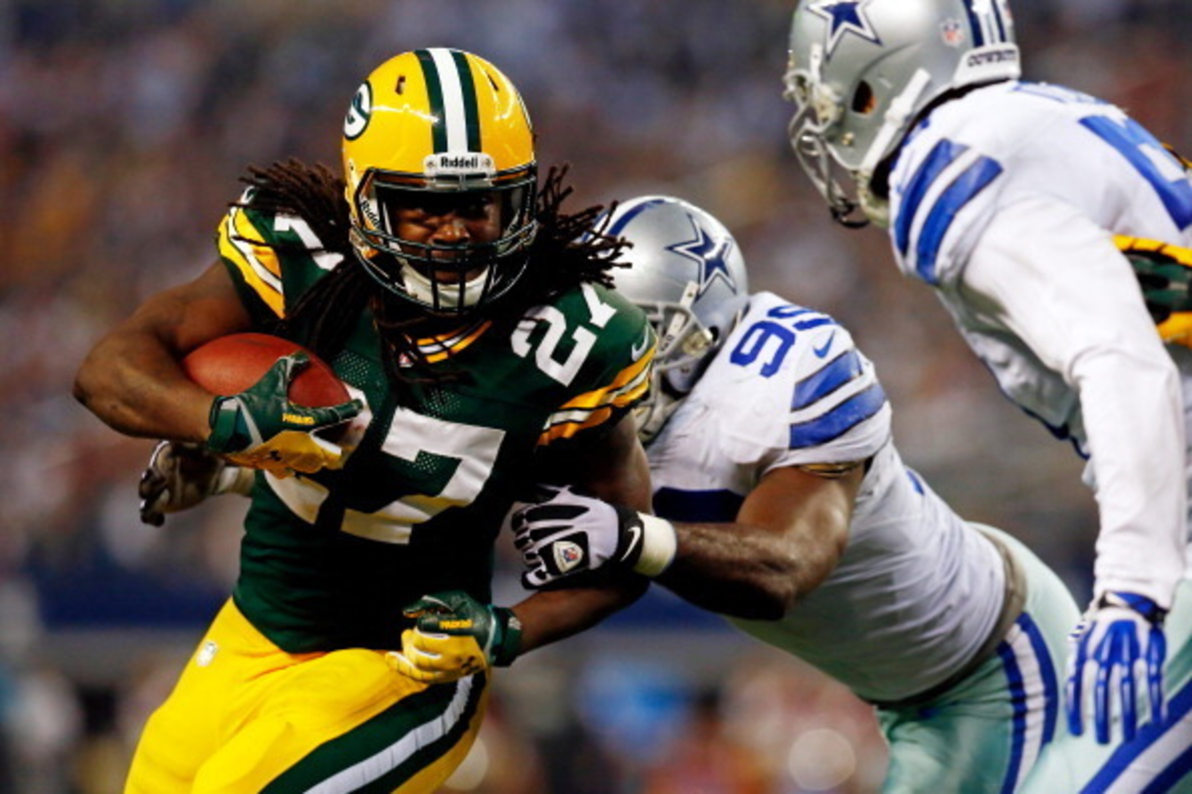 ARLINGTON, TX - DECEMBER 15:  Running back Eddie Lacy #27 of the Green Bay Packers runs with the ball as defensive end George Selvie #99 of the Dallas Cowboys defends during a game at AT&T Stadium on December 15, 2013 in Arlington, Texas.  (Photo by Tom P