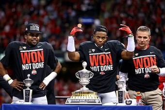NEW ORLEANS, LA - JANUARY 01:  Darron Lee (C) #43 and Ezekiel Elliott (L) #15 and head coach Urban Meyer (R) of the Ohio State Buckeyes celebrate with the trophy after defeating the Alabama Crimson Tide in the All State Sugar Bowl at the Mercedes-Benz Sup