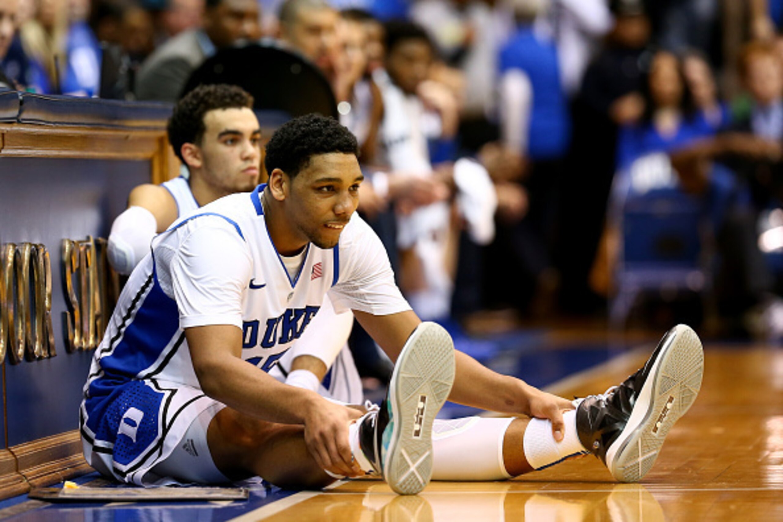 DURHAM, NC - DECEMBER 15:  Teammates Jahlil Okafor #15 and Tyus Jones #5 of the Duke Blue Devils wait to go into the game against the Elon Phoenix at Cameron Indoor Stadium on December 15, 2014 in Durham, North Carolina.  (Photo by Streeter Lecka/Getty Im