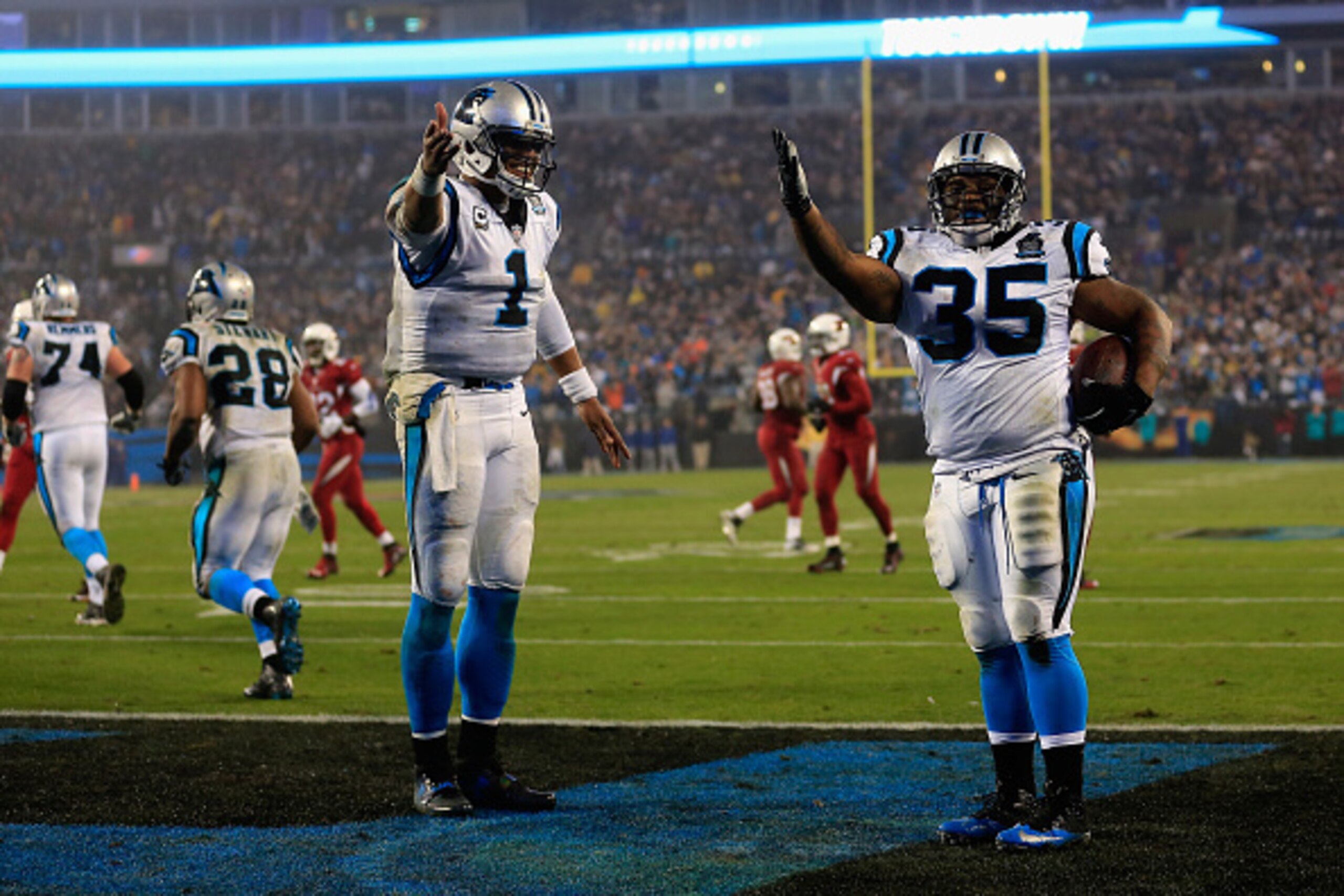 CHARLOTTE, NC - JANUARY 03: Quarterback Cam Newton #1 and fullback Mike Tolbert #35 of the Carolina Panthers celebrate after Tolbert caught a second half touchdown pass against the Arizona Cardinals during their NFC Wild Card Playoff game at Bank of Ameri