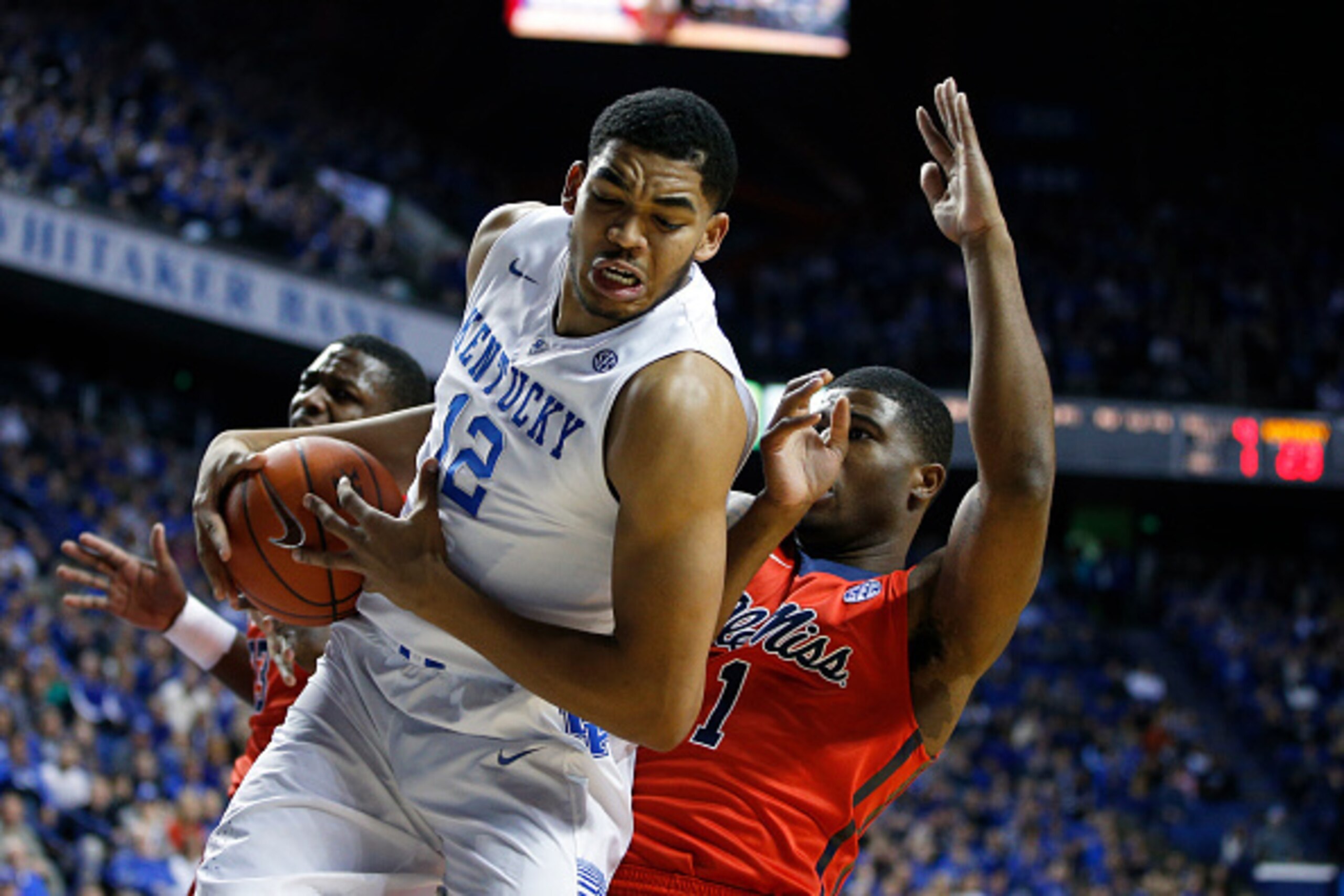 LEXINGTON, KY - JANUARY 6: Karl-Anthony Towns #12 of the Kentucky Wildcats rebounds against Martavious Newby #1 of the Mississippi Rebels in the first half of the game at Rupp Arena on January 6, 2015 in Lexington, Kentucky. (Photo by Joe Robbins/Getty Im