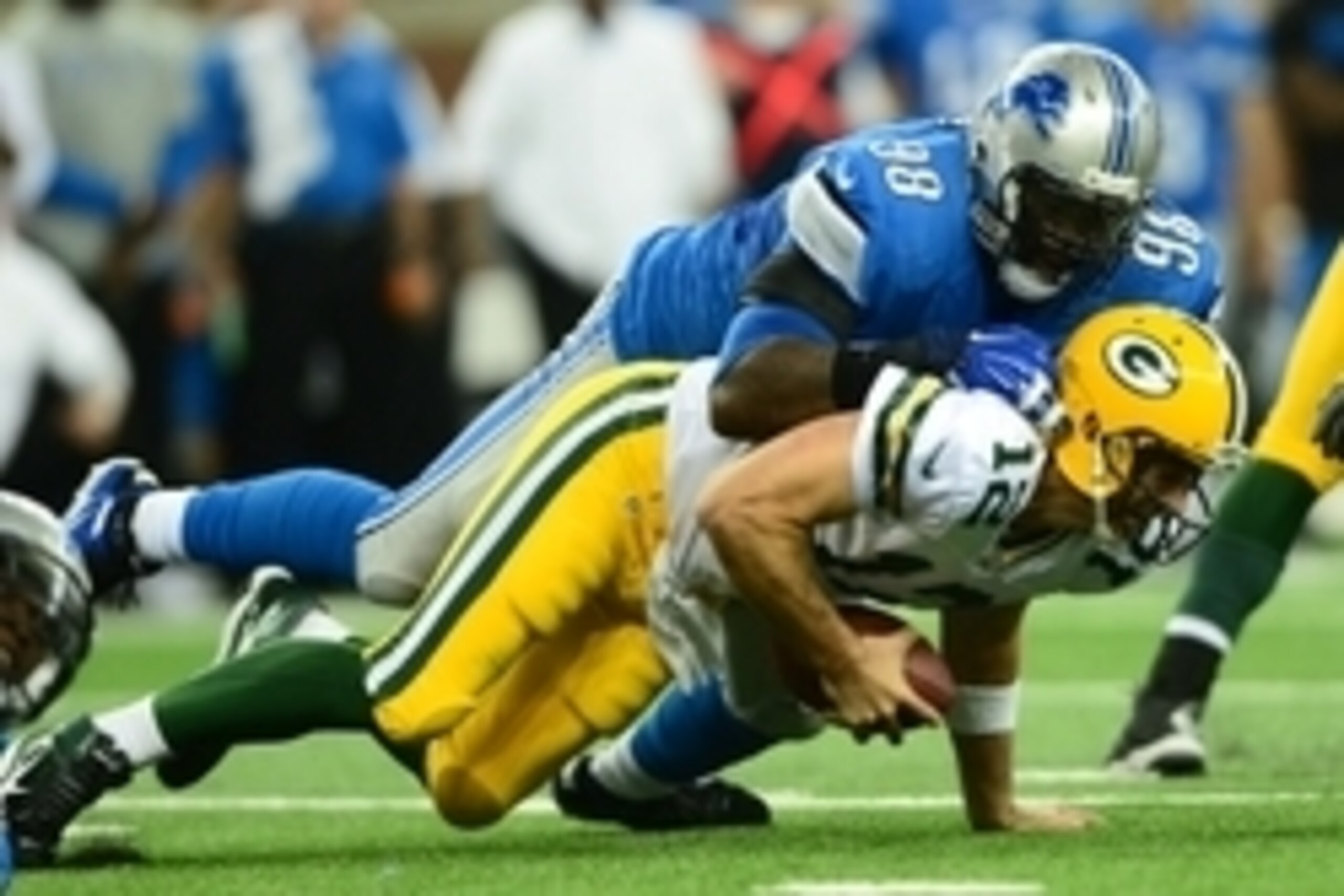 Sep 21, 2014; Detroit, MI, USA; Green Bay Packers quarterback Aaron Rodgers (12) is sacked by Detroit Lions defensive tackle Nick Fairley (98) during the third quarter at Ford Field. Mandatory Credit: Andrew Weber-USA TODAY Sports