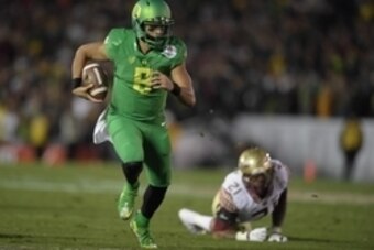 Jan 1, 2015; Pasadena, CA, USA; Oregon Ducks quarterback Marcus Mariota (8) scores on a 23-yard touchdown run in the fourth quarter against the Florida State Seminoles in the 2015 Rose Bowl college football game at Rose Bowl. Oregoon defeated Florida Stat
