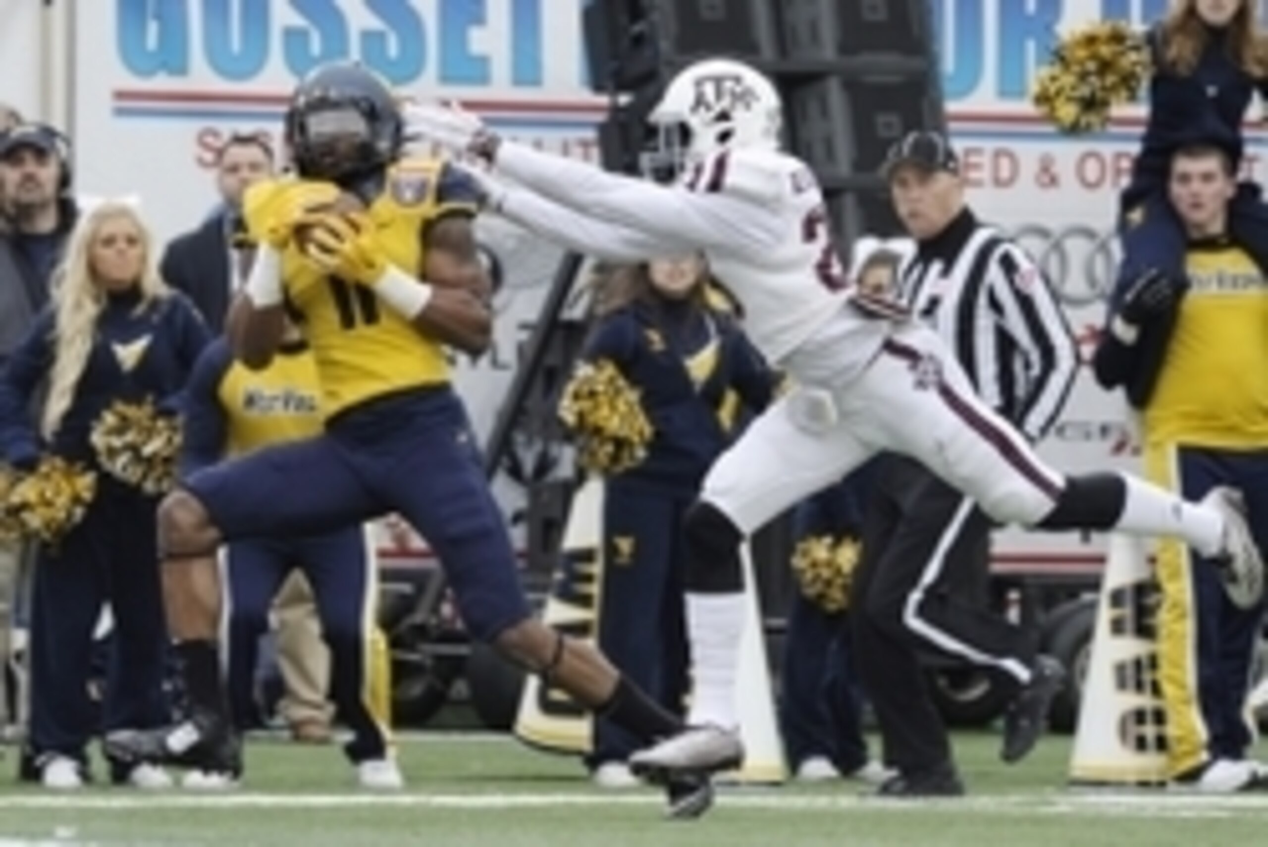 Dec 29, 2014; Memphis, TN, USA; West Virginia Mountaineers wide receiver Kevin White (11) catches a pass while defended by Texas A&M Aggies defensive back Deshazor Everett (29) during the game in the 2014 Liberty Bowl at Liberty Bowl Memorial Stadium. Man