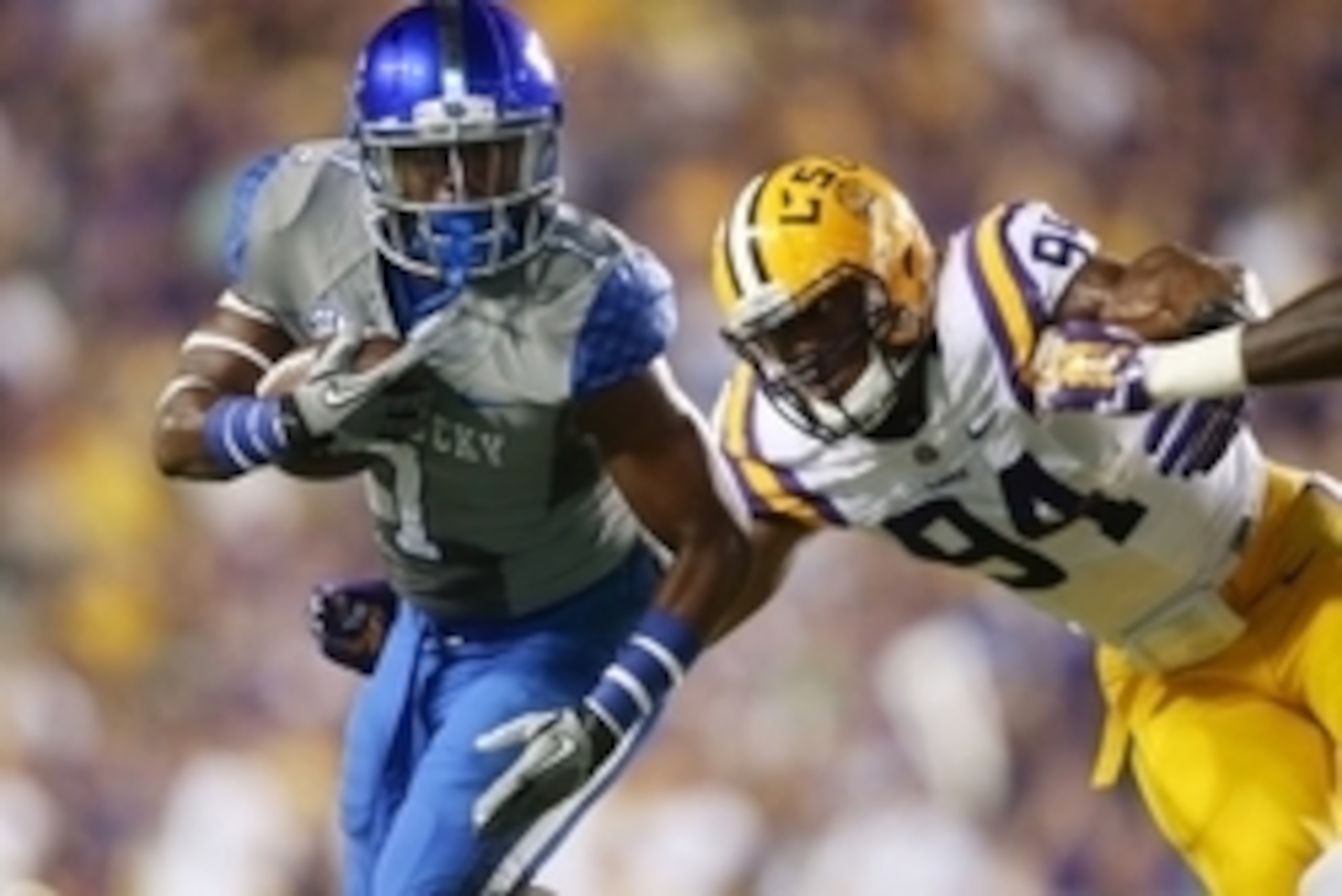 Oct 18, 2014; Baton Rouge, LA, USA; Kentucky Wildcats wide receiver Ryan Timmons (1) carries the ball in front of LSU Tigers defensive end Danielle Hunter (94) in the first half at Tiger Stadium. Mandatory Credit: Crystal LoGiudice-USA TODAY Sports