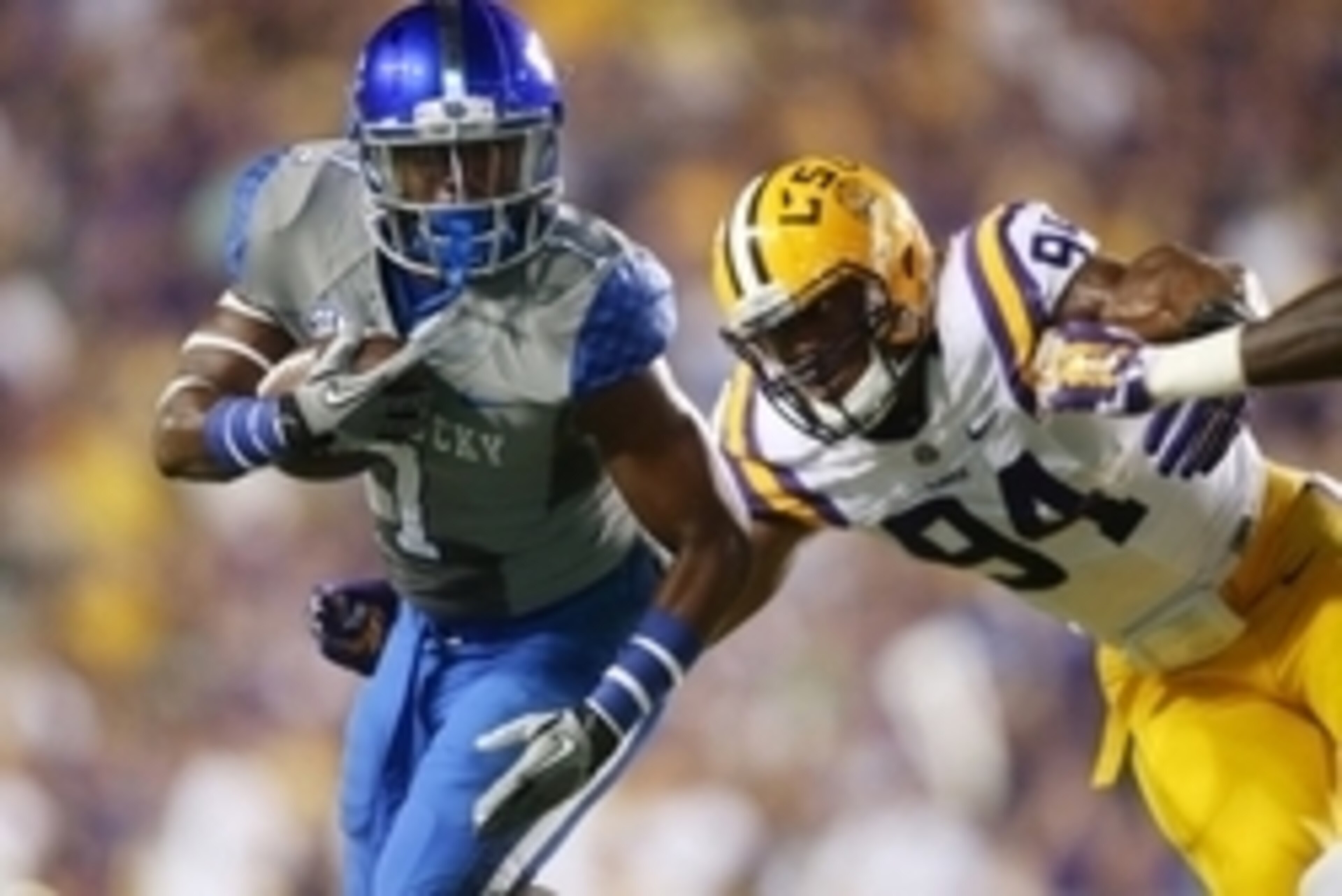 Oct 18, 2014; Baton Rouge, LA, USA; Kentucky Wildcats wide receiver Ryan Timmons (1) carries the ball in front of LSU Tigers defensive end Danielle Hunter (94) in the first half at Tiger Stadium. Mandatory Credit: Crystal LoGiudice-USA TODAY Sports