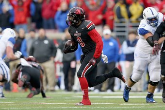 LOUISVILLE, KY - NOVEMBER 29:  Gerod Holliman #8 of the Louisville Cardinals runs with the ball after intercepting a pass during the game against the Kentucky Wildcats at Papa John's Cardinal Stadium on November 29, 2014 in Louisville, Kentucky.  (Photo b