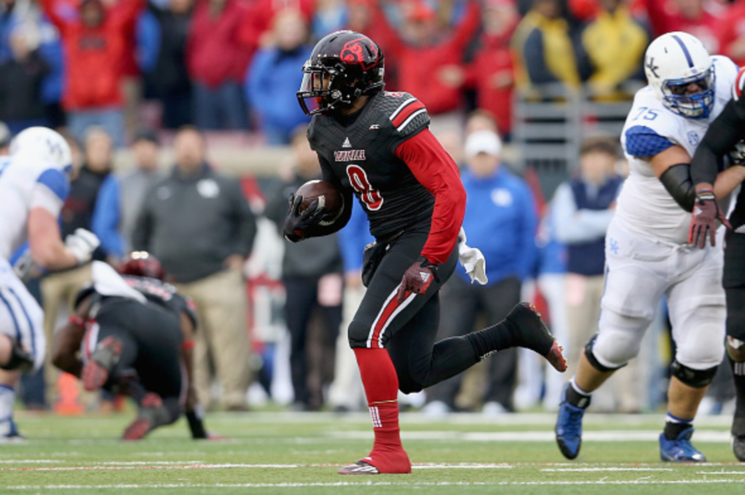 LOUISVILLE, KY - NOVEMBER 29:  Gerod Holliman #8 of the Louisville Cardinals runs with the ball after intercepting a pass during the game against the Kentucky Wildcats at Papa John's Cardinal Stadium on November 29, 2014 in Louisville, Kentucky.  (Photo b