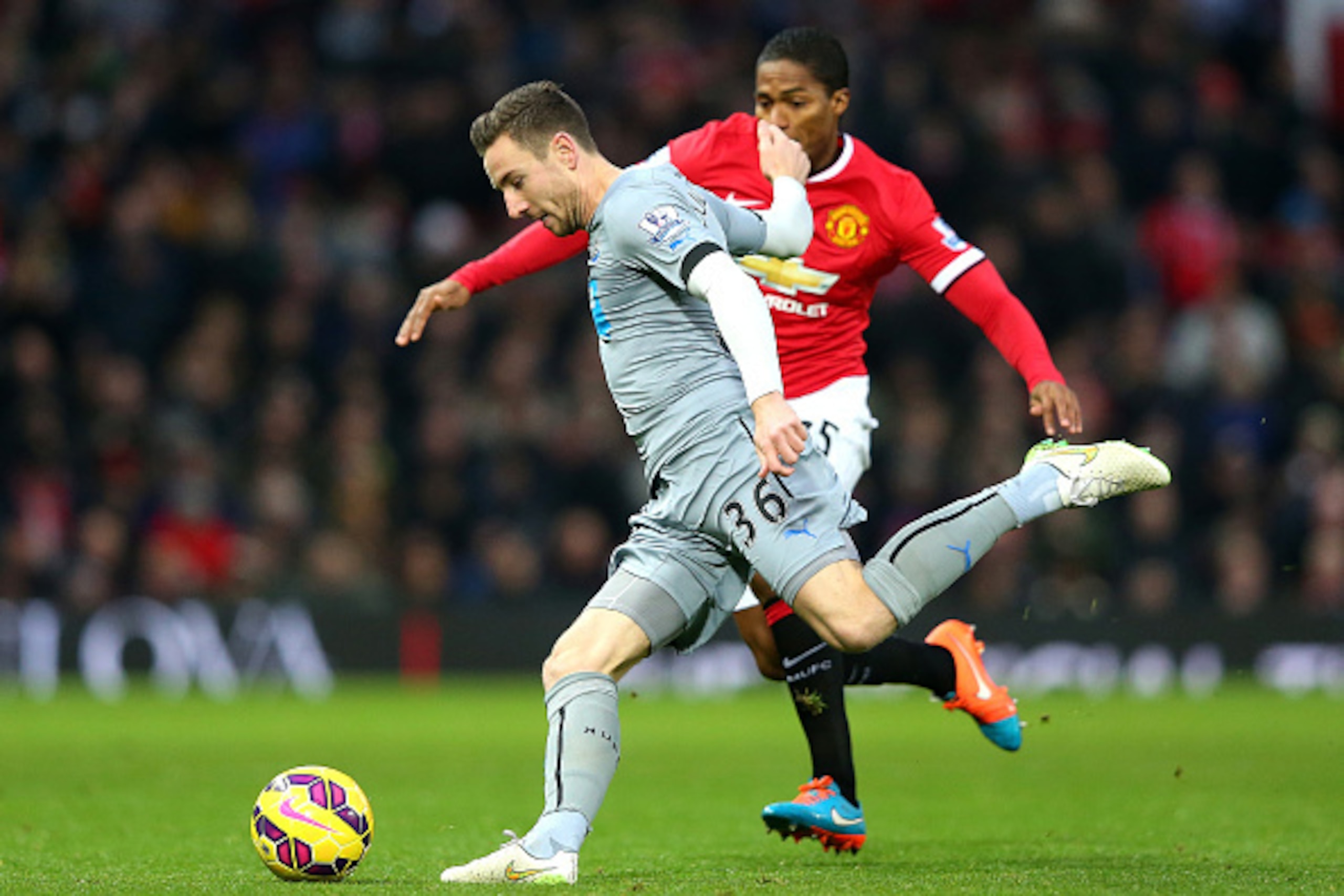 MANCHESTER, ENGLAND - DECEMBER 26:  Antonio Valencia of Manchester United competes with Paul Dummett of Newcastle United during the Barclays Premier League match between Manchester United and Newcastle United at Old Trafford on December 26, 2014 in Manche
