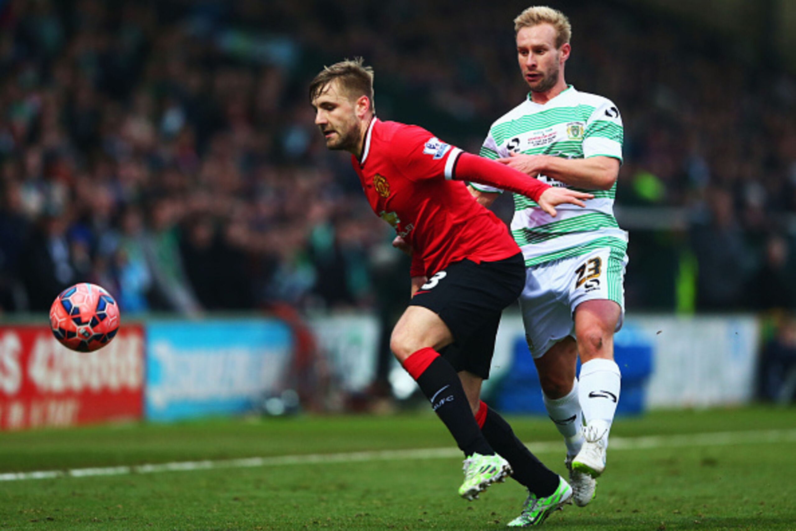 YEOVIL, ENGLAND - JANUARY 04: Luke Shaw of Manchester United holds off Simon Gillett of Yeovil Town during the FA Cup Third Round match between Yeovil Town and Manchester United at Huish Park on January 4, 2015 in Yeovil, England. (Photo by Michael Stee YEOVIL, ENGLAND - JANUARY 04: Luke Shaw of Manchester United holds off Simon Gillett of Yeovil Town during the FA Cup Third Round match between Yeovil Town and Manchester United at Huish Park on January 4, 2015 in Yeovil, England. (Photo by Michael Stee
