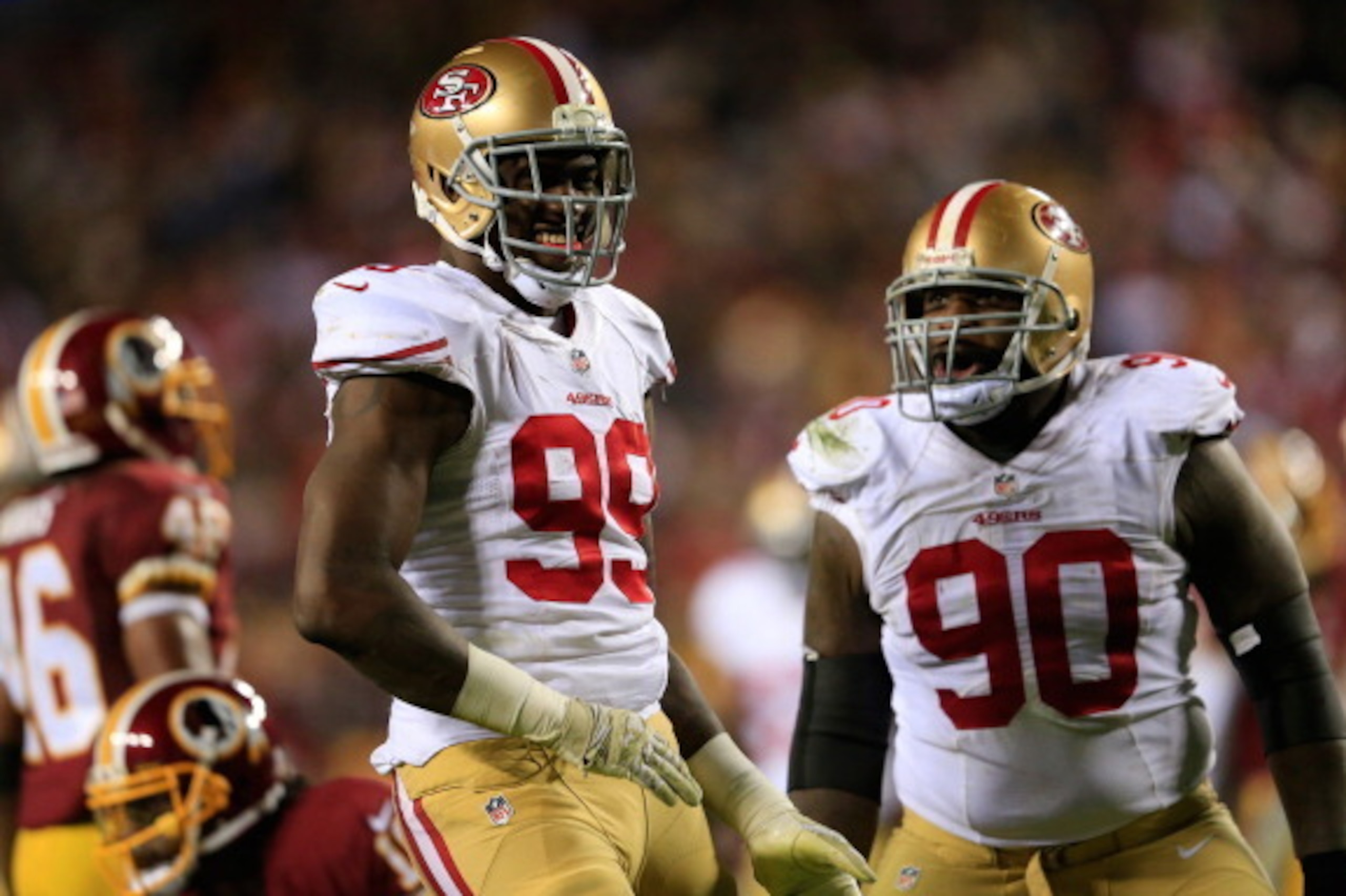 LANDOVER, MD - NOVEMBER 25: Outside linebacker Aldon Smith #99 and teammate nose tackle Glenn Dorsey #90 of the San Francisco 49ers celebrate Smith's sack of quarterback Robert Griffin III #10 of the Washington Redskins (not pictured) during the third qua
