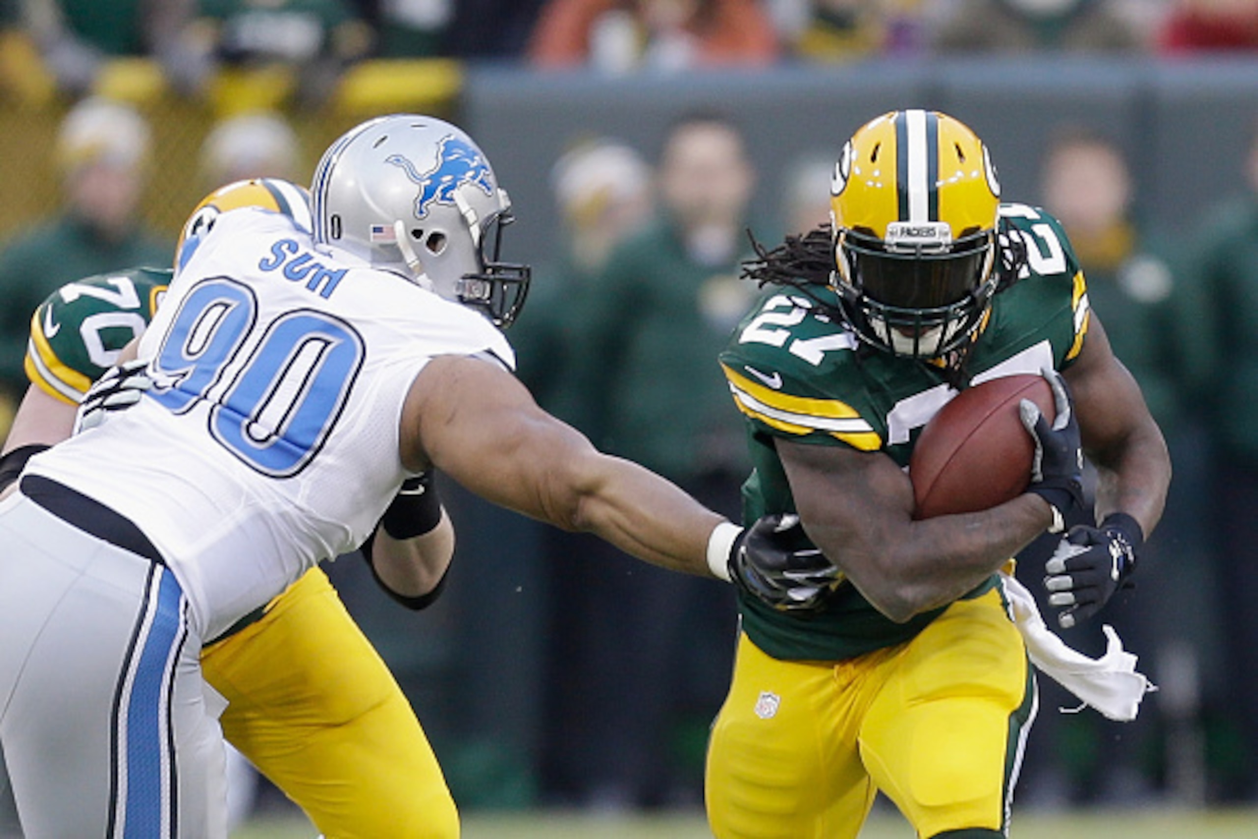 GREEN BAY, WI - DECEMBER 28:  Running back Eddie Lacy #27 of the Green Bay Packers runs for a first down against defensive tackle Ndamukong Suh #90 of the Detroit Lions, in the first quarter of the NFL game at Lambeau Field on December 28, 2014 in Green B