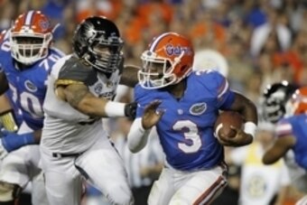 Oct 18, 2014; Gainesville, FL, USA; Florida Gators quarterback Treon Harris (3) runs with the ball as Missouri Tigers defensive lineman Shane Ray (56) defends during the first half at Ben Hill Griffin Stadium. Mandatory Credit: Kim Klement-USA TODAY Sport