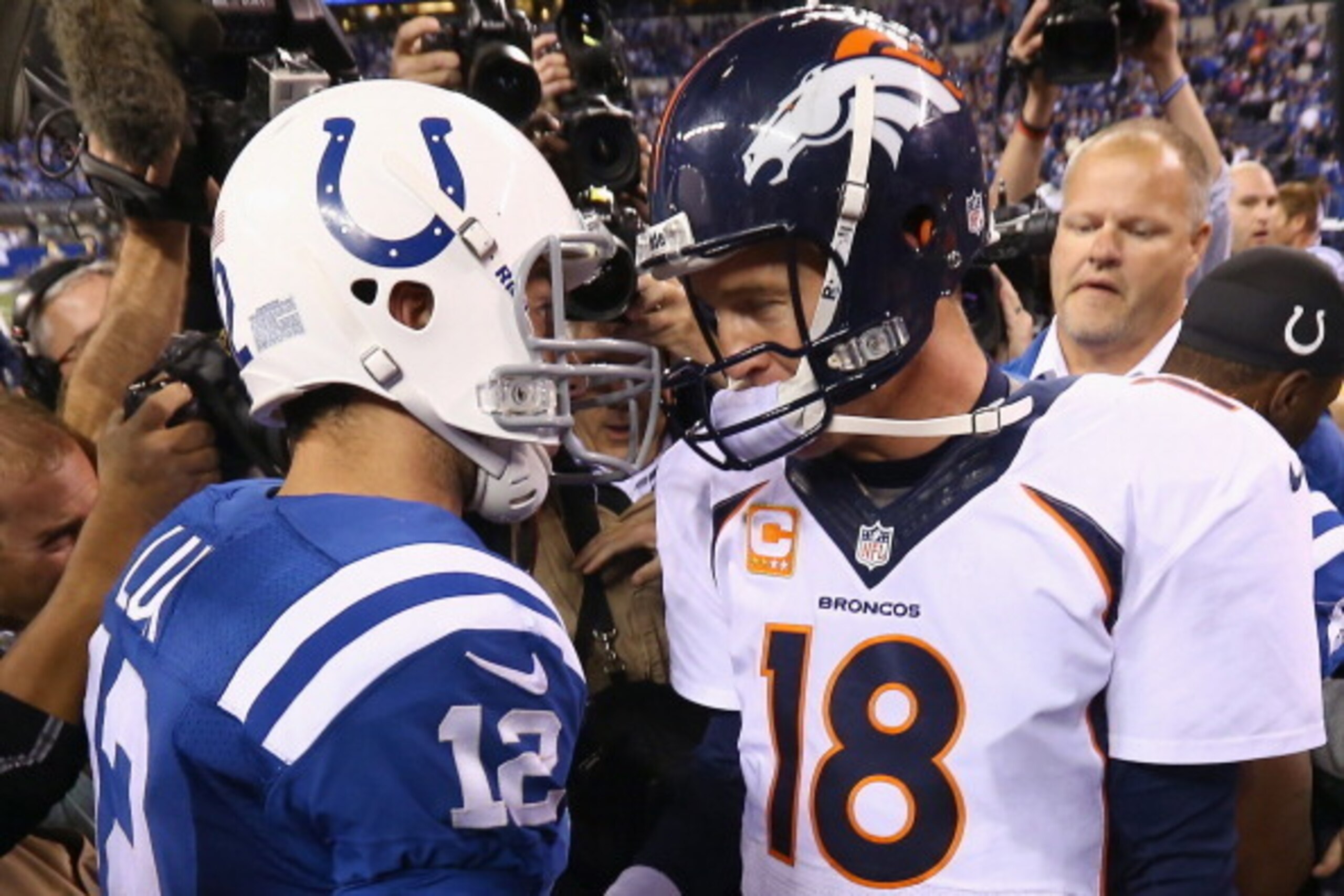 INDIANAPOLIS, IN - OCTOBER 20:  Andrew Luck #12 of the Indianapolis Colts and Peyton Manning #18 of the Denver Broncos meet after the game at Lucas Oil Stadium on October 20, 2013 in Indianapolis, Indiana. The Colts won 39-33.  (Photo by Andy Lyons/Getty 