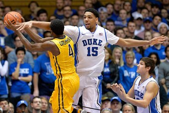 DURHAM, NC - DECEMBER 29:  Jahlil Okafor #15 of the Duke Blue Devils defends a drive by Justin Drummond #4 of the Toledo Rockets during their game at Cameron Indoor Stadium on December 29, 2014 in Durham, North Carolina.  (Photo by Grant Halverson/Getty I