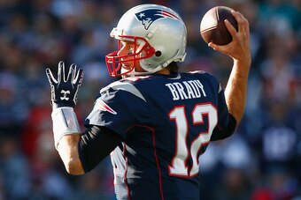 FOXBORO, MA - DECEMBER 14:  Tom Brady #12 of the New England Patriots passes the ball during the first quarter against the Miami Dolphins at Gillette Stadium on December 14, 2014 in Foxboro, Massachusetts.  (Photo by Jared Wickerham/Getty Images)