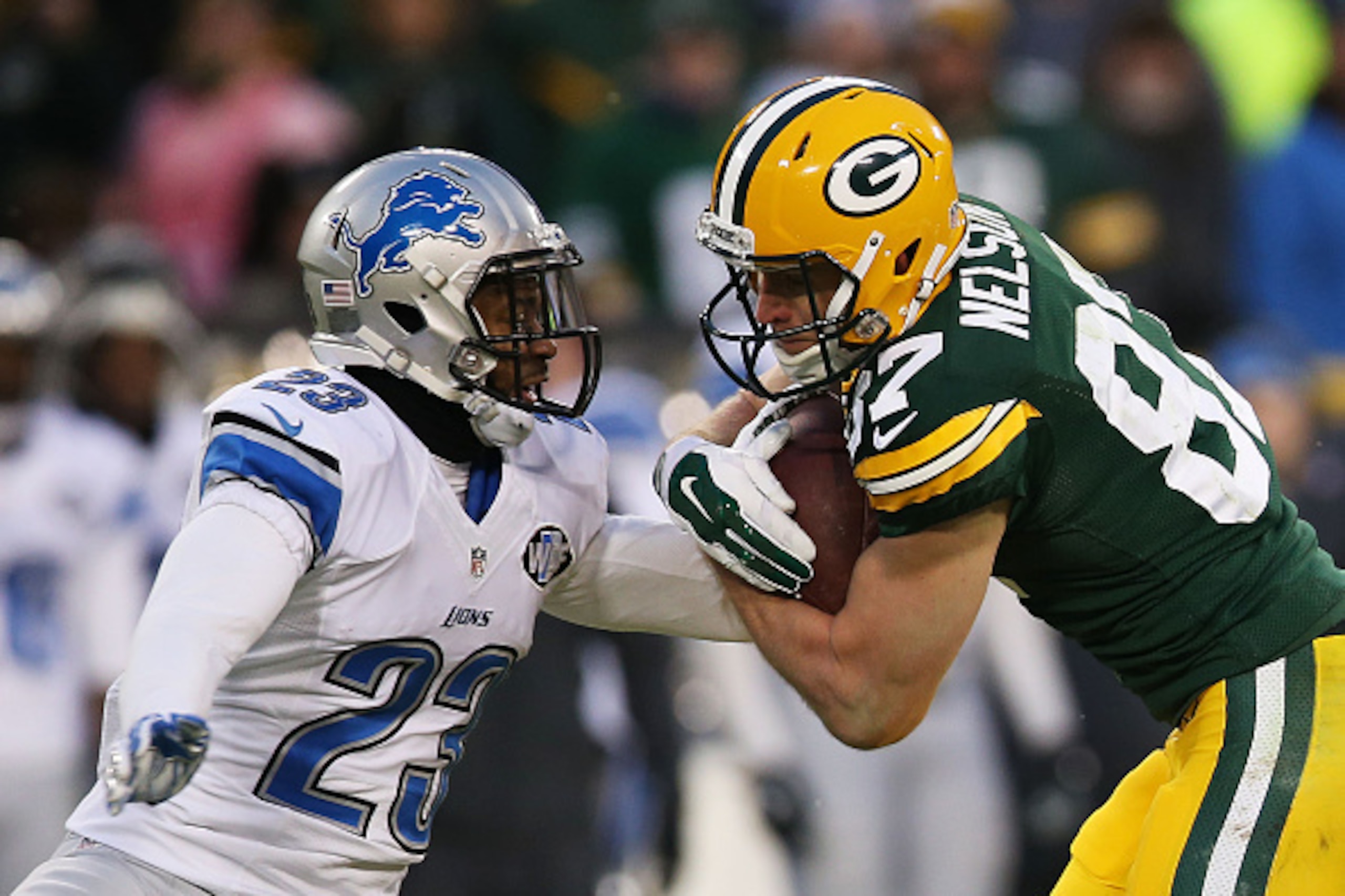 GREEN BAY, WI - DECEMBER 28:   Jordy Nelson #87 of the Green Bay Packers tries to avoid the tackle of  Darius Slay #23 of the Detroit Lions in the second quarter at Lambeau Field on December 28, 2014 in Green Bay, Wisconsin.  (Photo by Chris Graythen/Gett