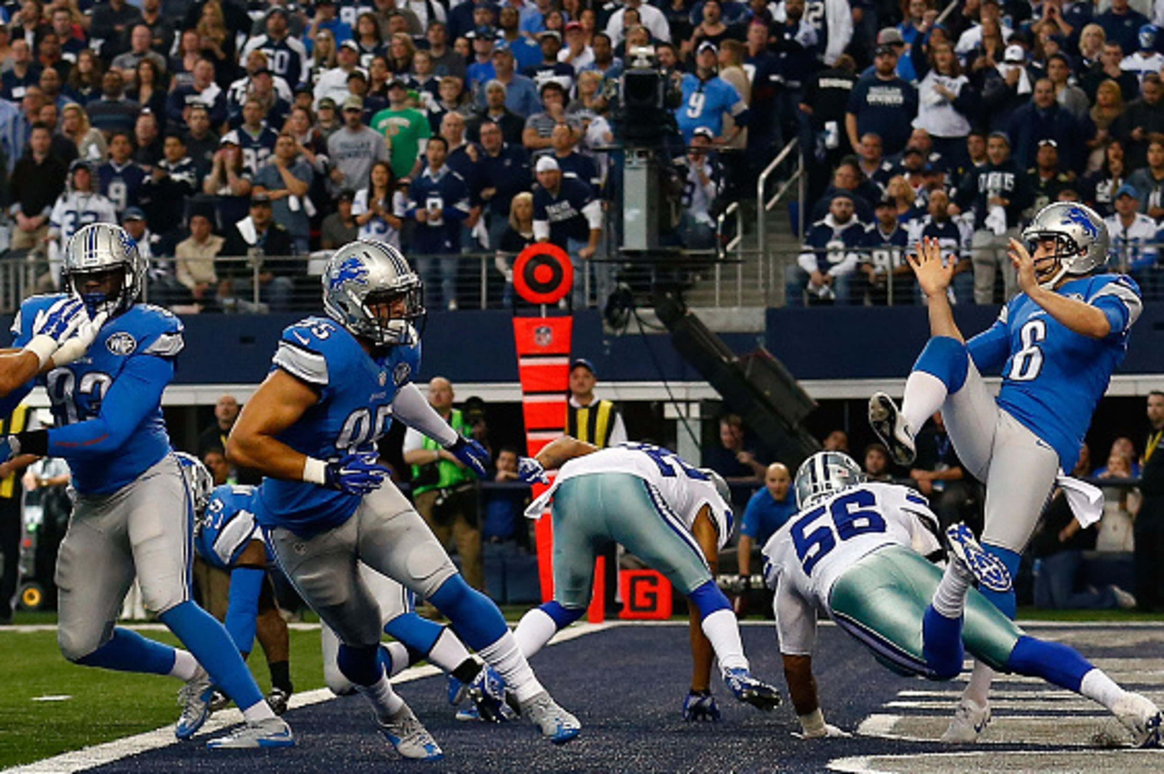 ARLINGTON, TX - JANUARY 04:  Dekoda Watson #56 of the Dallas Cowboys roughs punter Sam Martin #6 of the Detroit Lions as George Johnson #93 of the Detroit Lions and K.Van Noy #95 of the Detroit Lions block during the first half of their NFC Wild Card Play