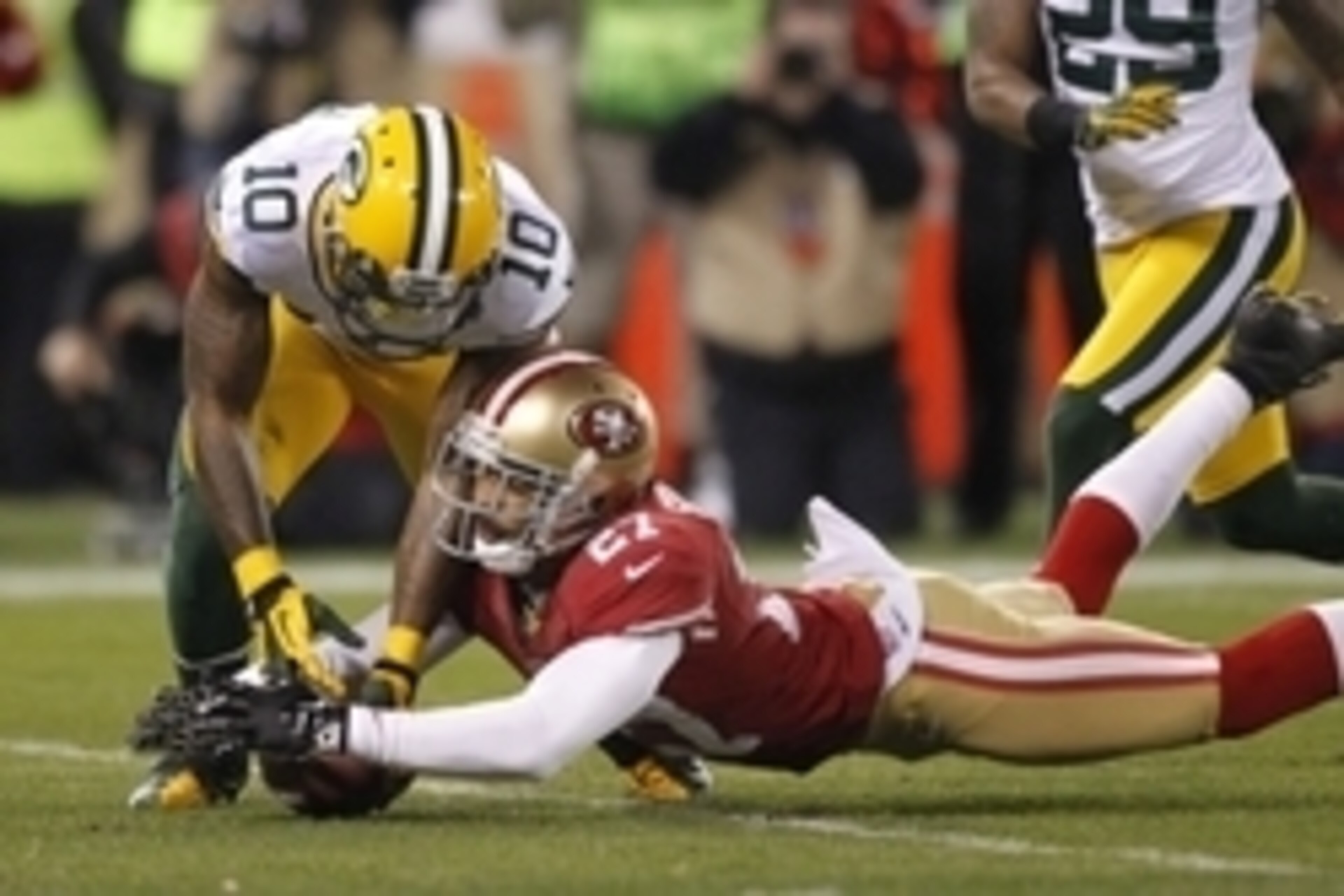 Jan 12, 2013; San Francisco, CA, USA; San Francisco 49ers safety C.J. Spillman (27) dives for the ball after a dropped punt catch by Green Bay Packers wide receiver Jeremy Ross (10) during the second quarter of the NFC divisional round playoff game at Can