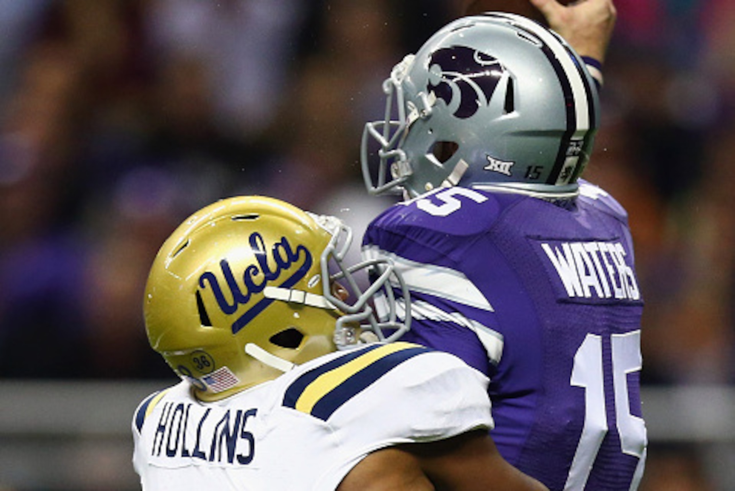 SAN ANTONIO, TX - JANUARY 02:  Jake Waters #15 of the Kansas State Wildcats is tackled by Deon Hollins #58 of the UCLA Bruins in the first quarter during the Valero Alamo Bowl at Alamodome on January 2, 2015 in San Antonio, Texas.  (Photo by Ronald Martin