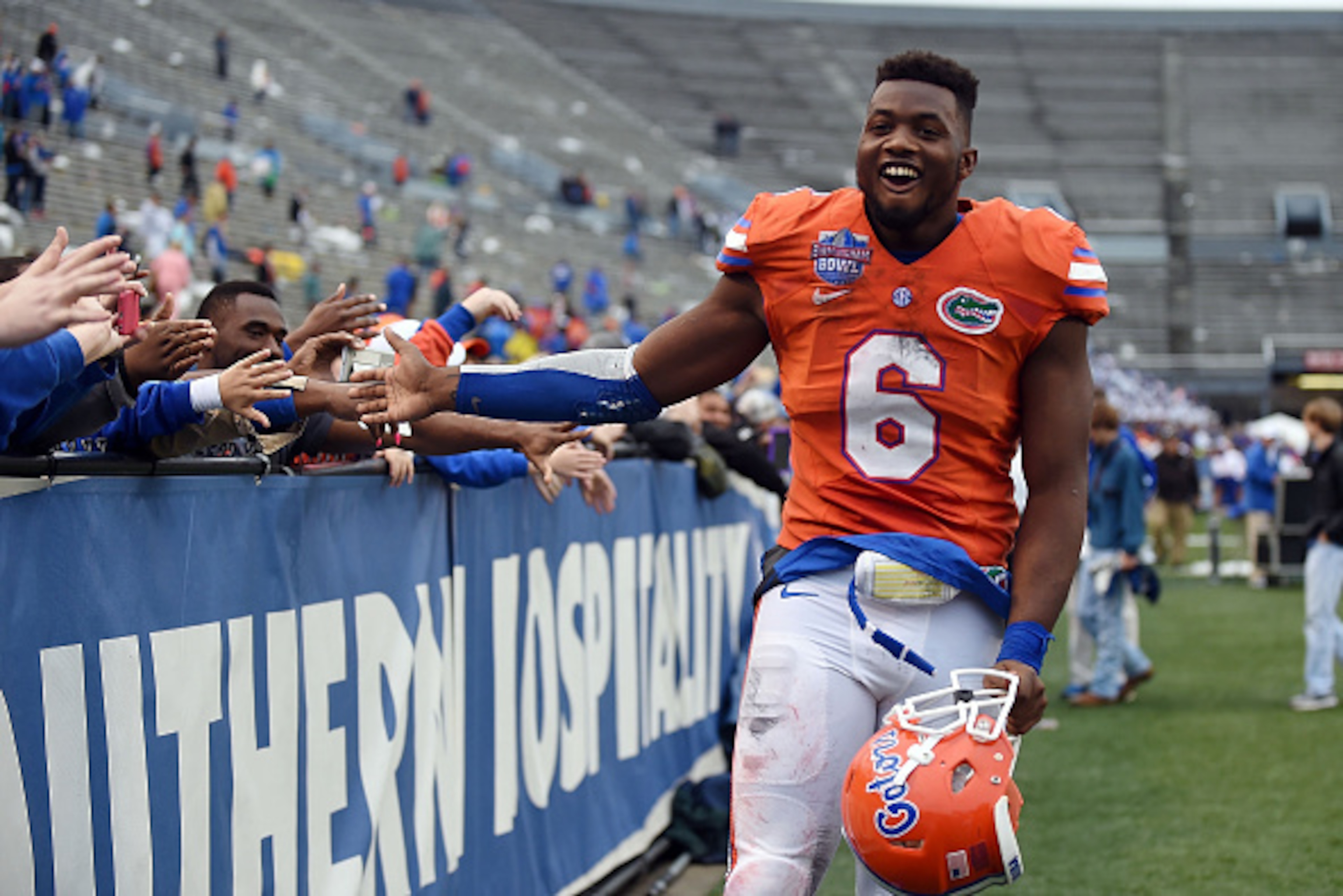 BIRMINGHAM, AL - JANUARY 03:  Dante Fowler #6 of the Florida Gators celebrates with fans following a victory over the East Carolina Pirates in the Birmingham Bowl at Legion Field on January 3, 2015 in Birmingham, Alabama.  (Photo by Stacy Revere/Getty Ima