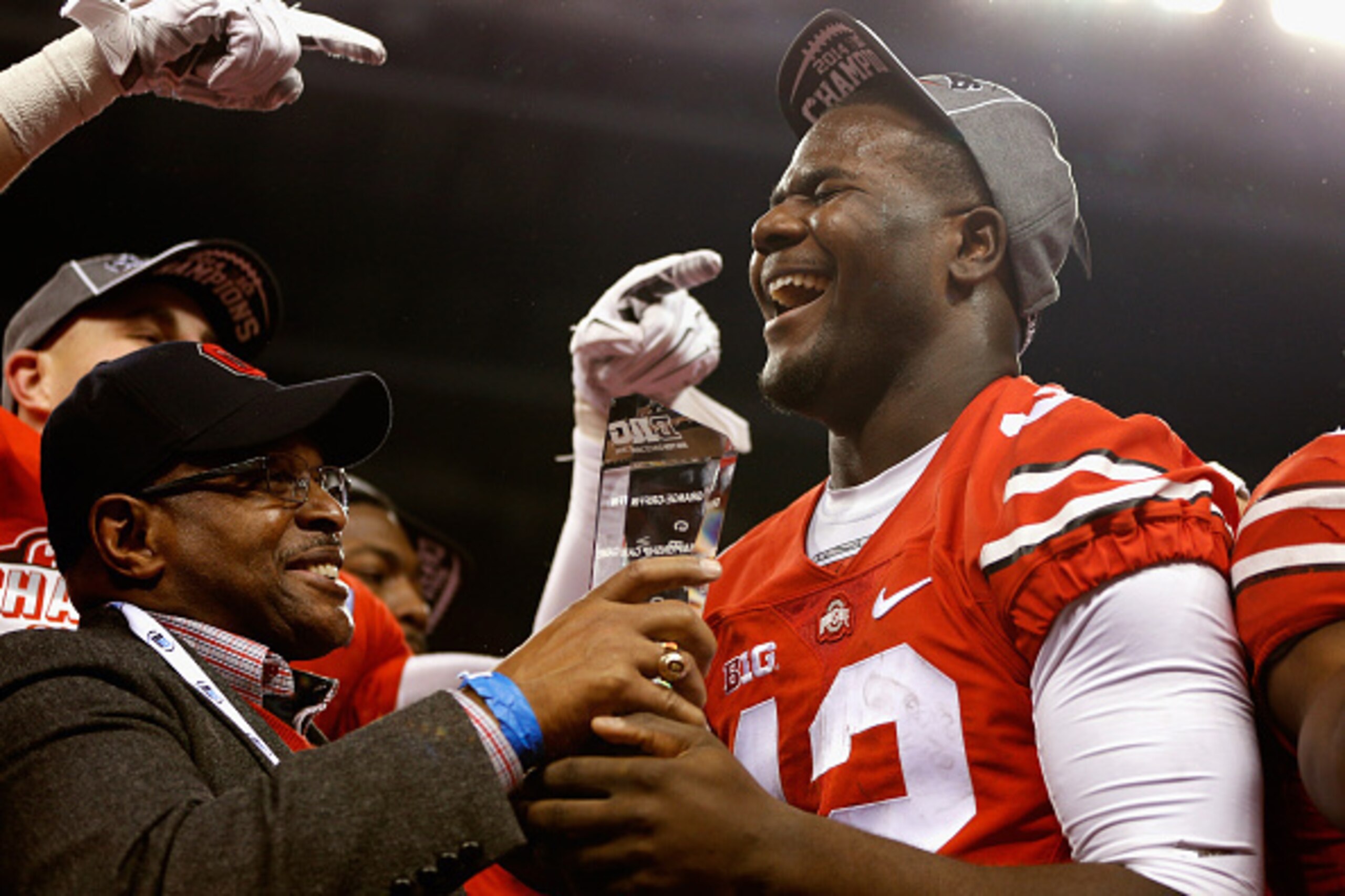 INDIANAPOLIS, IN - DECEMBER 06:  Quarterback Cardale Jones #12 of the Ohio State Buckeyes celebrates with the Stagg Championship Trophy after his team defeated the Wisconsin Badgers 59-0 in the Big Ten Championship at Lucas Oil Stadium on December 6, 2014