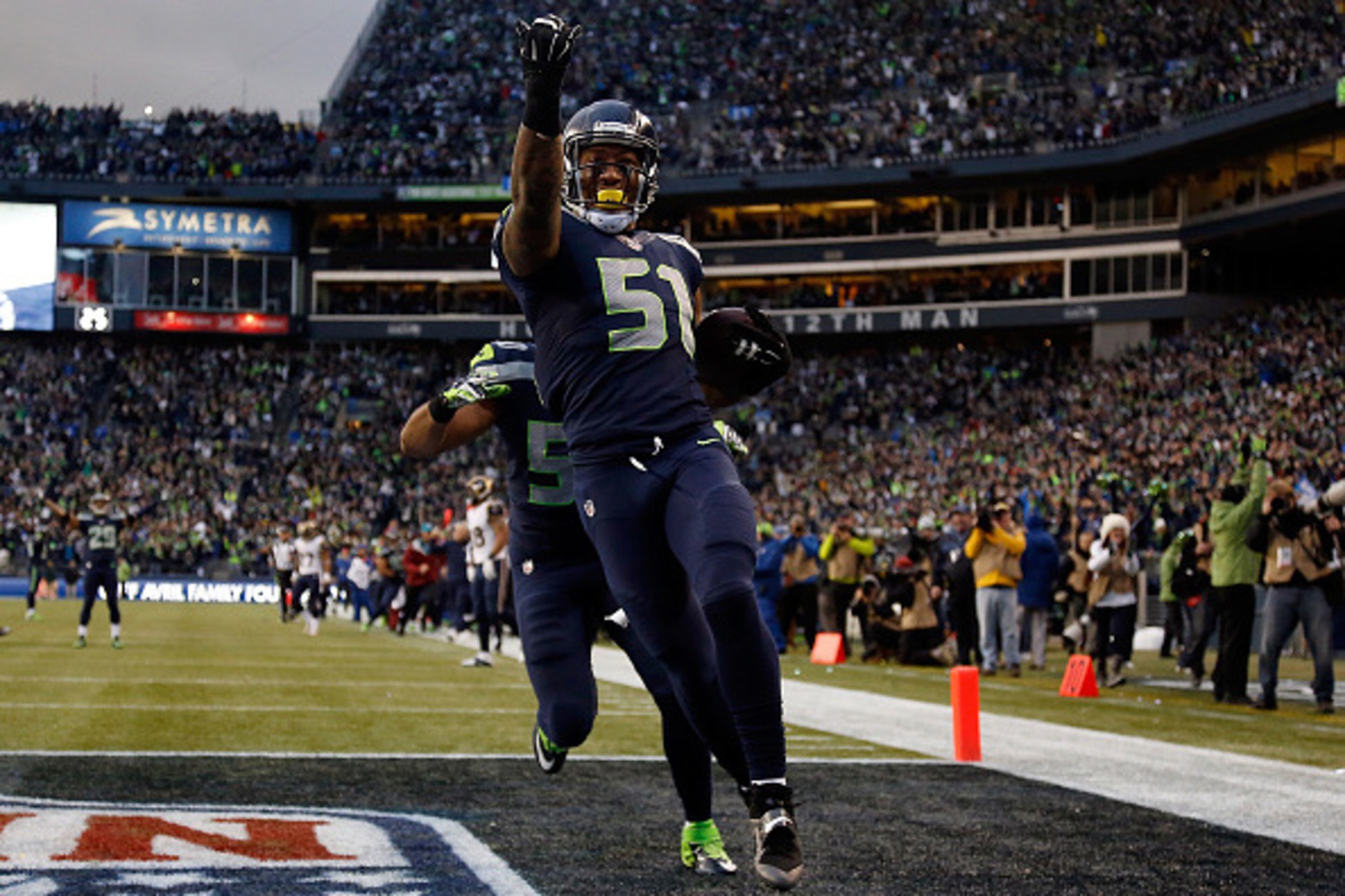 SEATTLE, WA - DECEMBER 28: Outside linebacker Bruce Irvin #51 of the Seattle Seahawks celebrates after running an interception back 49 yards for a touchdown during the fourth quarter of the game against the St. Louis Rams at CenturyLink Field on December 