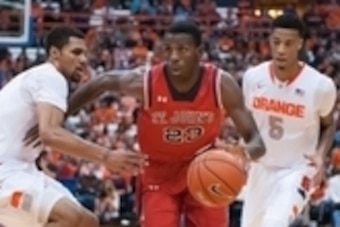 Dec 6, 2014; Syracuse, NY, USA; St. John's Red Storm guard Rysheed Jordan (23) splits the defense of Syracuse Orange guard Michael Gbinije (left) and forward Chris McCullough (5) during the first half of a game at the at Carrier Dome. Mandatory Credit: Ma