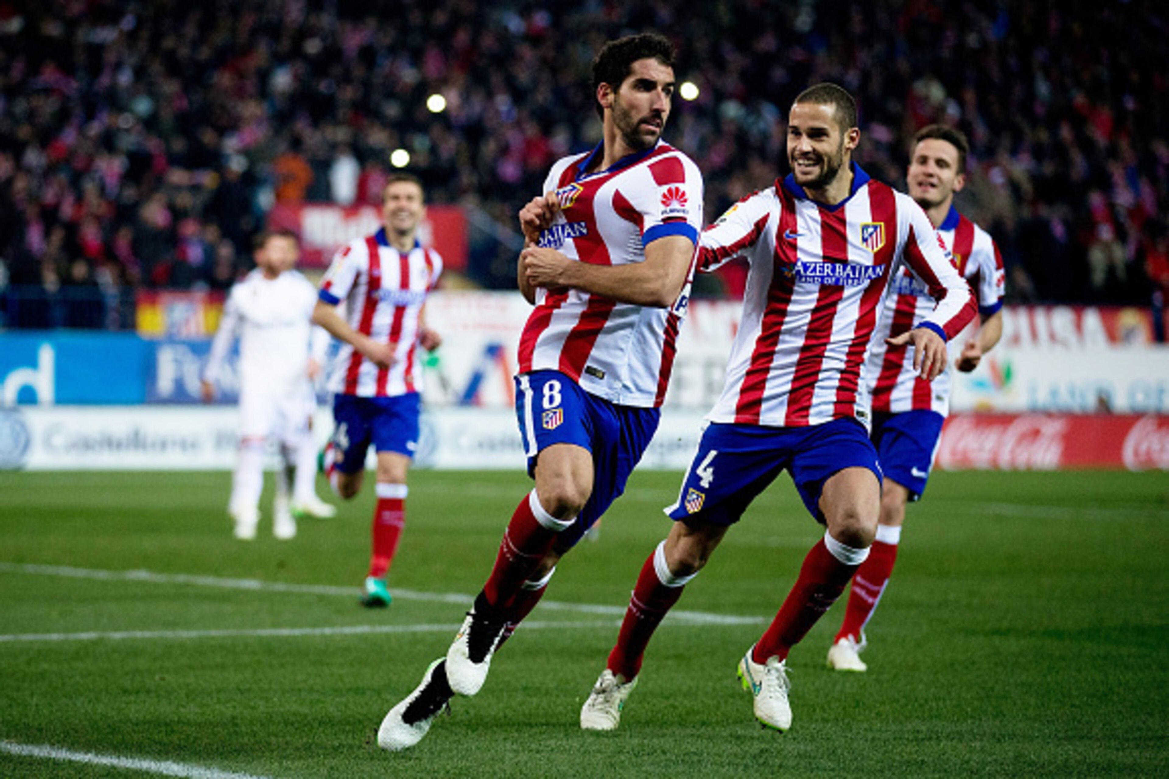 MADRID, SPAIN - JANUARY 07: Raul Garcia (R) of Atletico de Madrid celebrates scoring their opening goal with his teammate Mario Suarez (L) during the Copa del Rey Round of 16 first leg match between Club Atletico de Madrid and Real Madrid CF at Vicente Ca MADRID, SPAIN - JANUARY 07: Raul Garcia (R) of Atletico de Madrid celebrates scoring their opening goal with his teammate Mario Suarez (L) during the Copa del Rey Round of 16 first leg match between Club Atletico de Madrid and Real Madrid CF at Vicente Ca