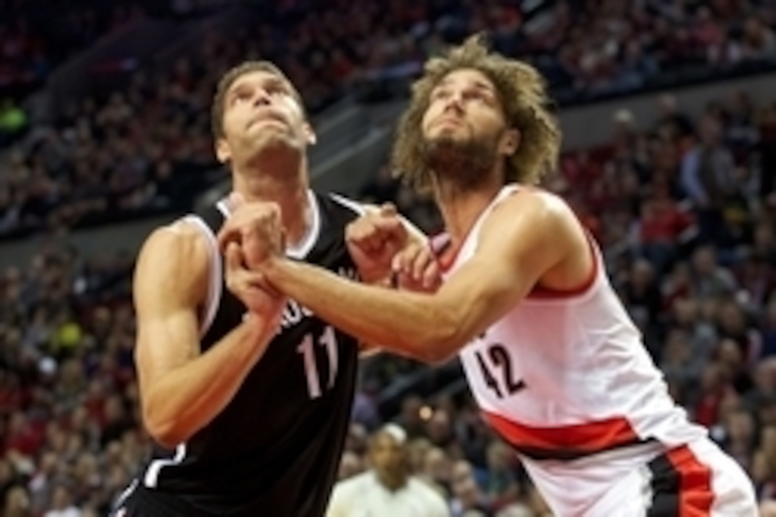 Nov 15, 2014; Portland, OR, USA; Brooklyn Nets center Brook Lopez (11) and Portland Trail Blazers center Robin Lopez (42) position themselves for a rebound after a free throw at Moda Center at the Rose Quarter. Mandatory Credit: Jaime Valdez-USA TODAY Spo