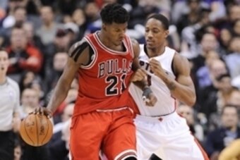 Nov 13, 2014; Toronto, Ontario, CAN;  Chicago Bulls guard Jimmy Butler (21)  clashes with Toronto Raptors guard DeMar DeRozan (10) during the fourth quarter at Air Canada Centre. Chicago won 100 - 93. Mandatory Credit: Peter Llewellyn-USA TODAY Sports