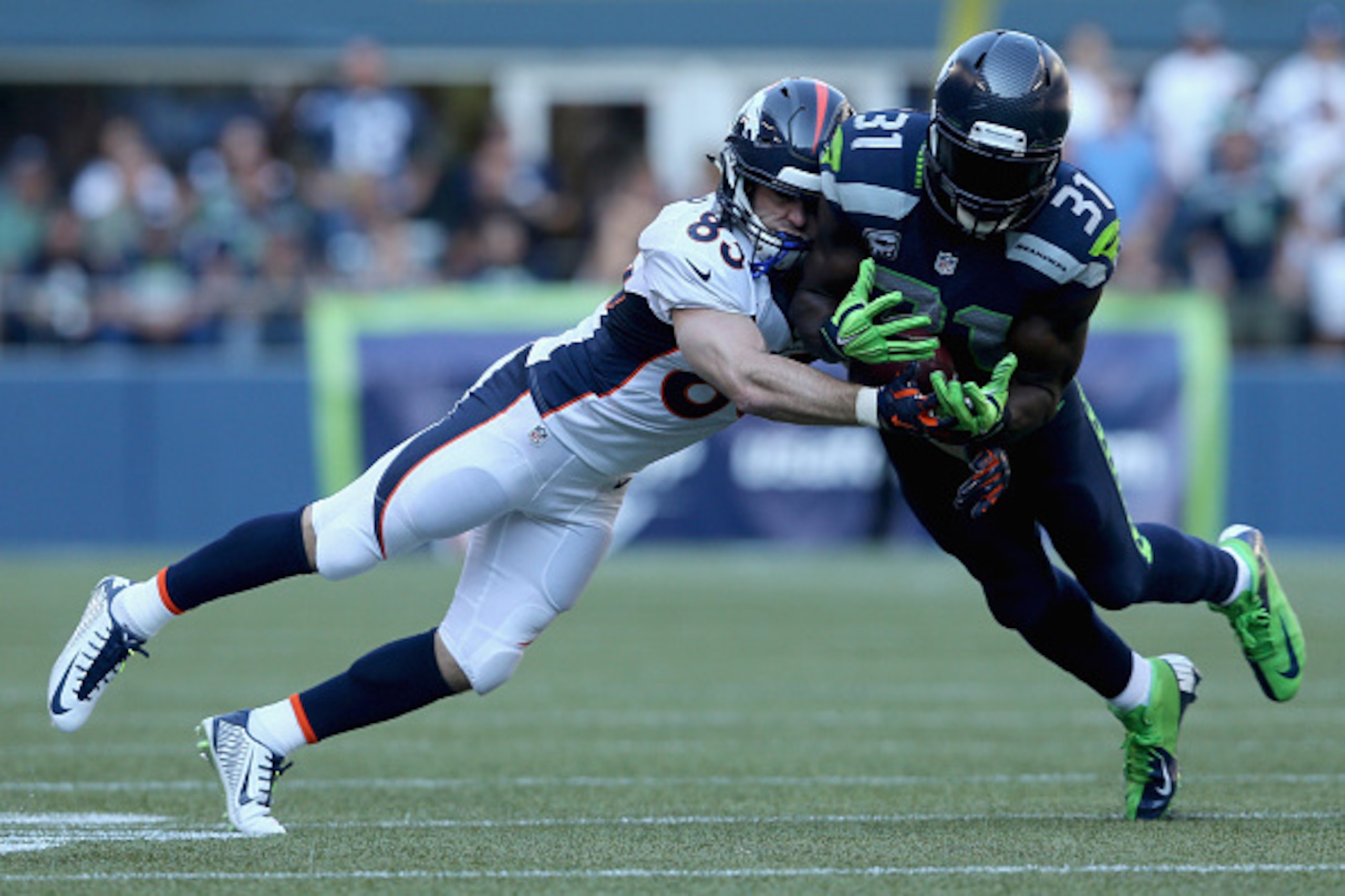 SEATTLE, WA - SEPTEMBER 21:  Strong safety Kam Chancellor #31 of the Seattle Seahawks breaks up a pass intended for wide receiver Wes Welker #83 of the Denver Broncos during the third quarter at CenturyLink Field on September 21, 2014 in Seattle, Washingt