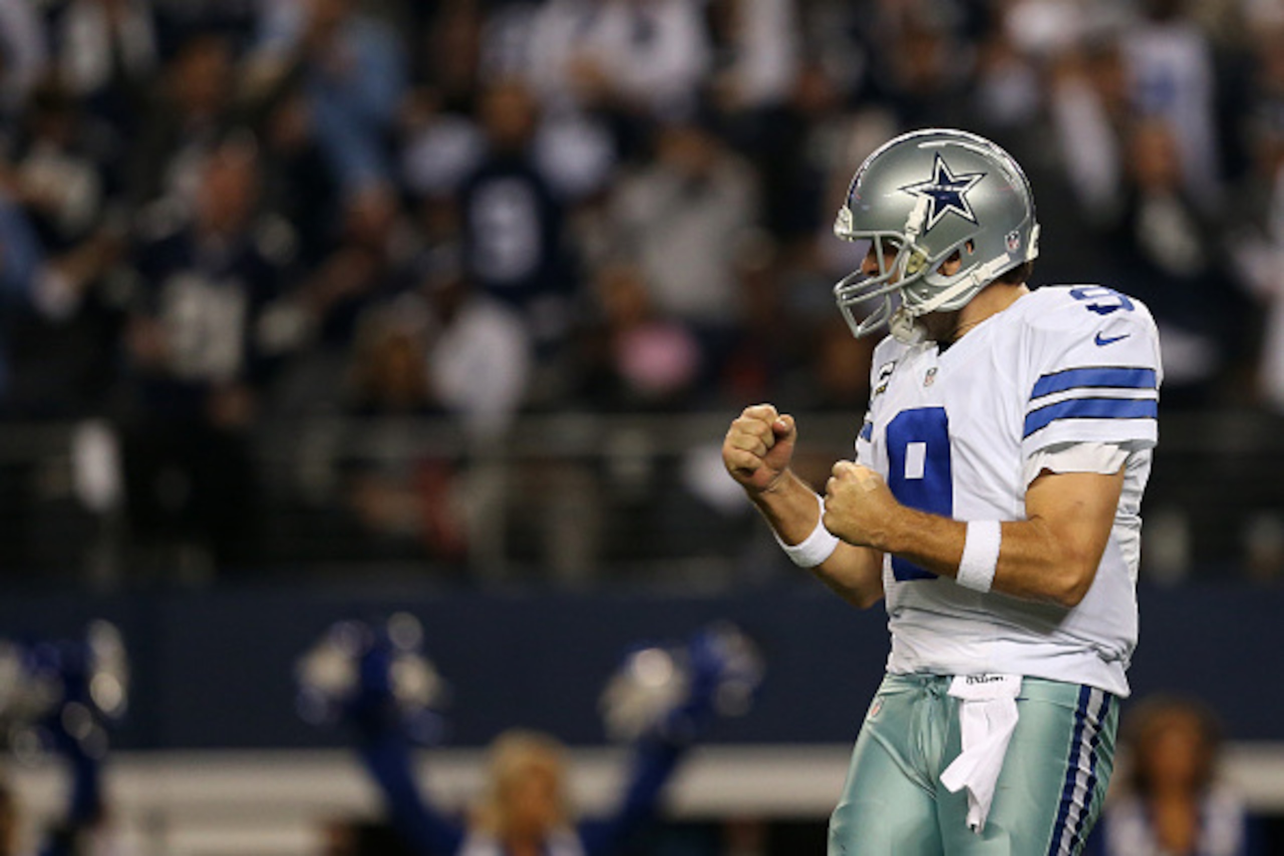 ARLINGTON, TX - JANUARY 04:  Tony Romo #9 of the Dallas Cowboys celebrates during a NFC Wild Card Playoff game against the Detroit Lions at AT&T Stadium on January 4, 2015 in Arlington, Texas.  (Photo by Sarah Glenn/Getty Images)