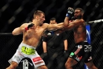 Jun 14, 2014; Vancouver, British Columbia, Canada; Rory MacDonald (red) fights against Tyron Woodley (blue) in their welterweight bout at UFC 174 at Rogers Arena. Mandatory Credit: Anne-Marie Sorvin-USA TODAY Sports